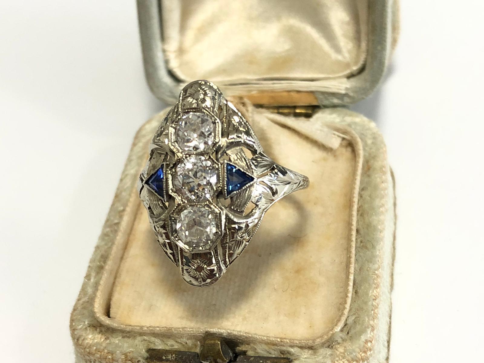 Set to the front with old brilliant and triangle sapphires, between bifurcated shoulders, diamonds approx. 1,8ct. total, ring size 15