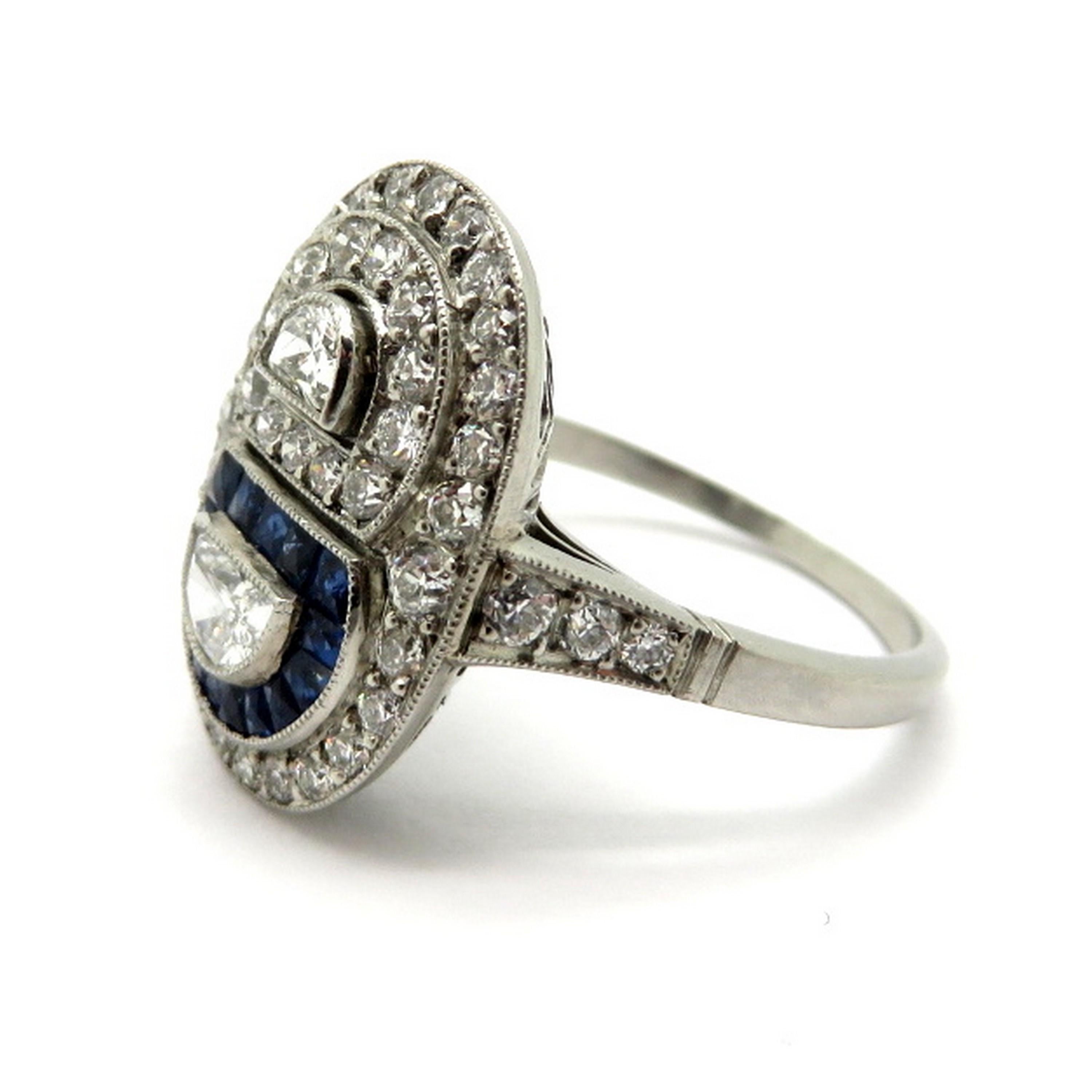Platinum sapphire and diamond half-moon shaped Art Deco style engagement ring. Showcasing two fancy half-moon shaped diamonds, weighing a total of 0.29 carats, having H – I color grade and VS1 clarity grade. Accented with 15 fine quality natural