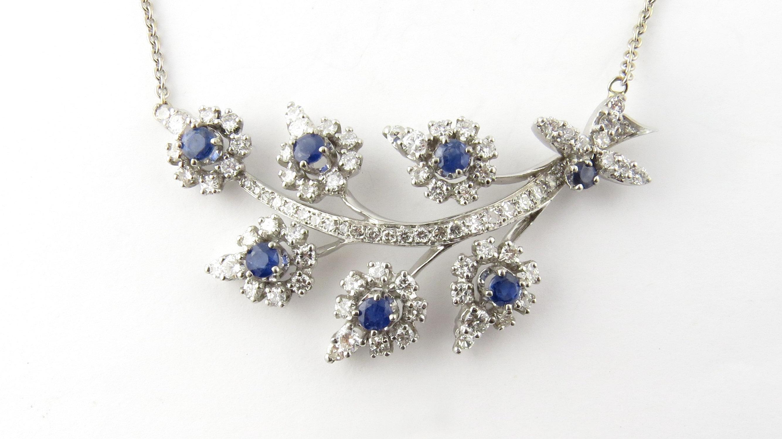 Vintage Platinum Sapphire and Diamond Necklace- 
This spectacular piece features a sparkling spray of diamond and sapphire flowers decorated with 58 round brilliant cut diamonds (1.8 ct. twt.), 32 single-cut diamonds (.70 ct. twt.) and seven round