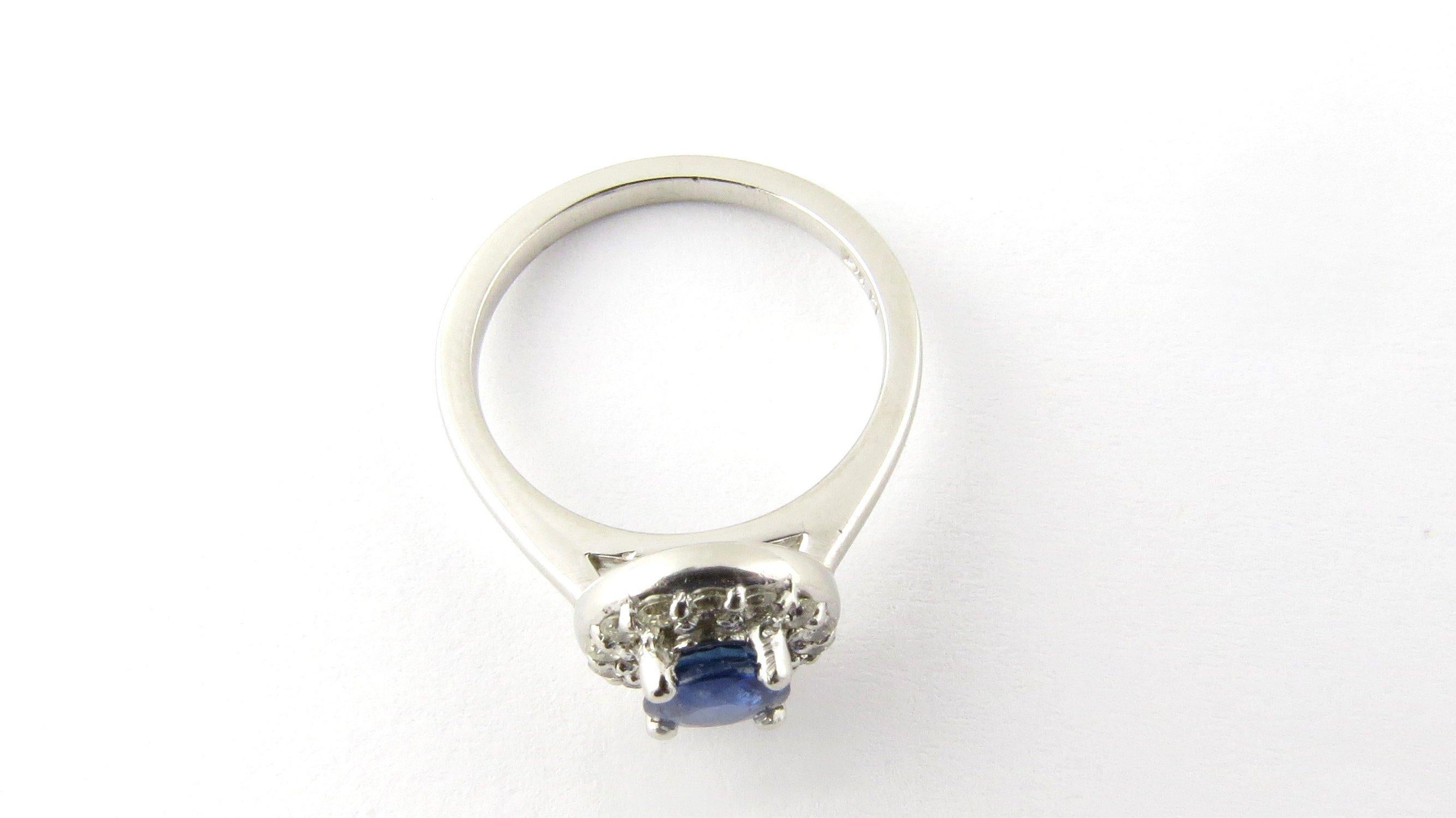 Vintage Platinum Natural Blue Sapphire and Diamond Ring 4.5-

This sparkling ring features one natural blue round sapphire (5 mm) surrounded by 14 round brilliant cut diamonds set in classic platinum.  Top of ring measures 9 mm.  Shank measures 1.5