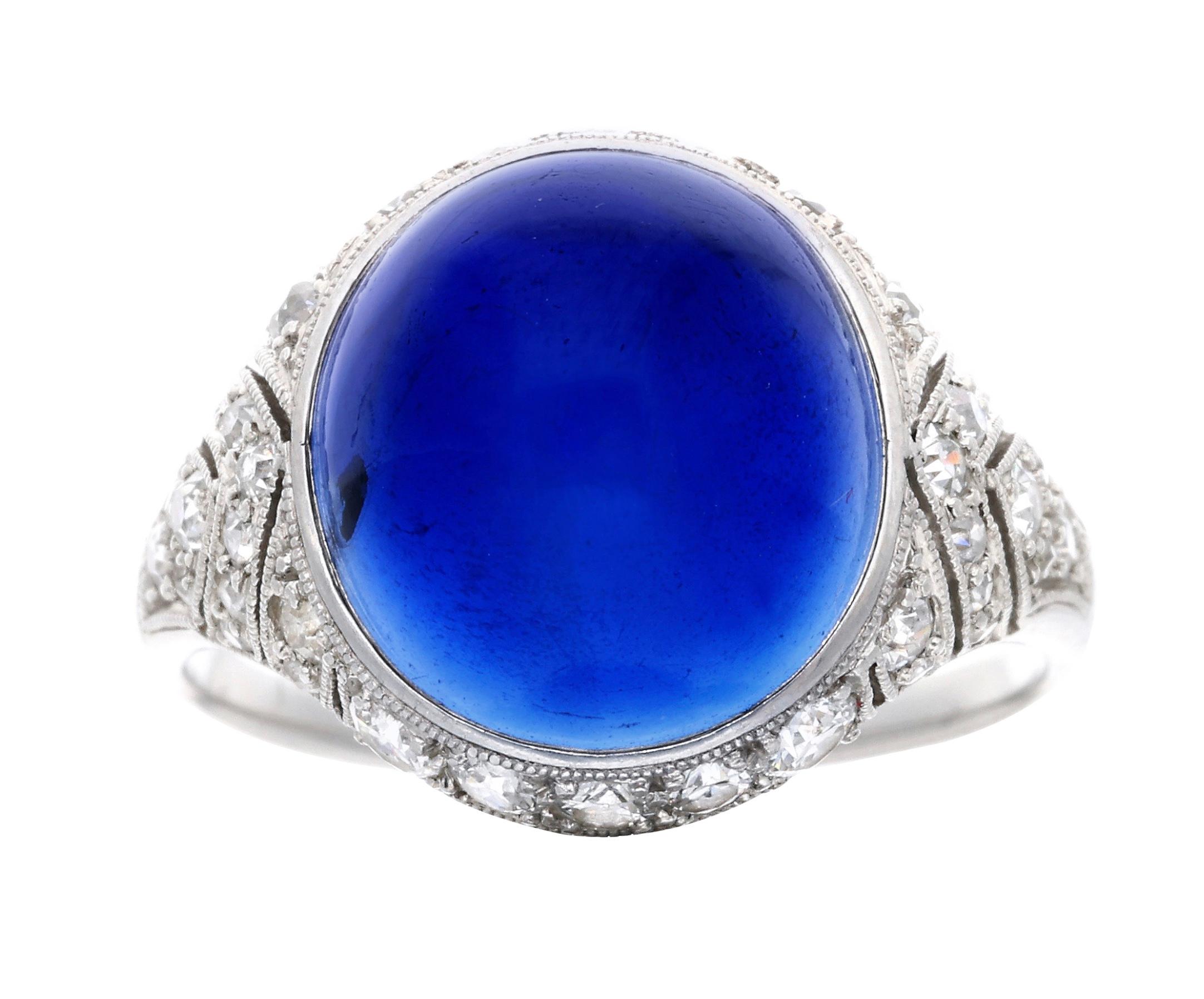 An eye-catching oval cabochon sapphire that is accented by round diamonds.

- Sapphire weighs approximately 8.55 carats
- Diamonds weigh a total of approximately 0.55 carat
- Platinum
- Total weight 6 grams
- Size 6.25

The condition report is Very
