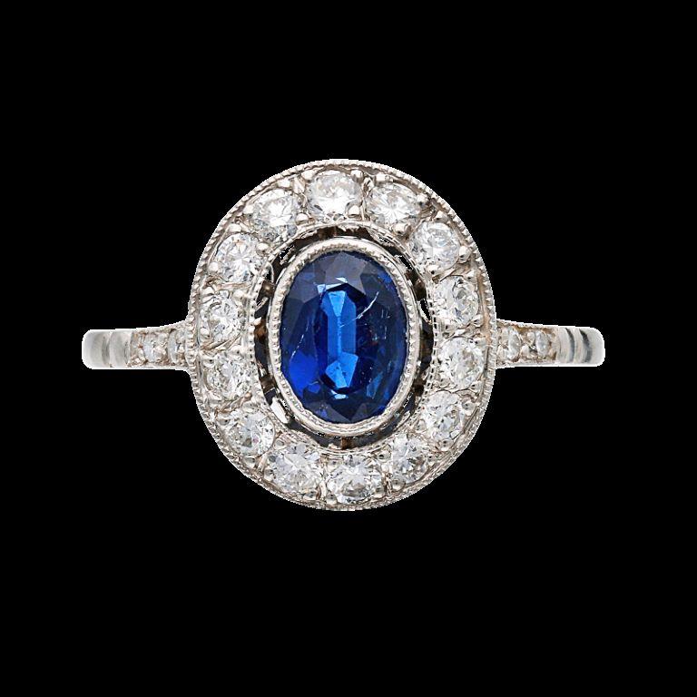 Centering an oval-shaped sapphire, surrounded by diamonds.

Sapphire weighs a total of 0.75 carat
Diamonds weighing a total of approximately 0.70 carat
Platinum
Size 7 1/2
