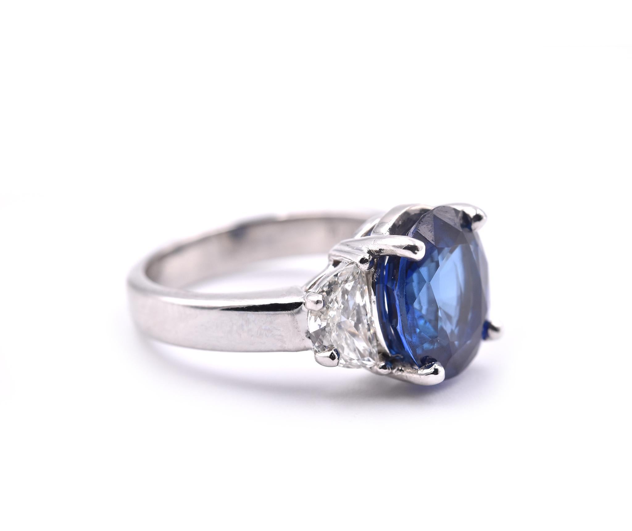 Designer: custom design
Material: platinum
Sapphire: 1 oval cut= 4.10ct  GIA Cert# 2205232384
Diamonds: 2 half-moon cut= 1.00cttw
Ring Size: 5 ½ (please allow two additional shipping days for any sizing requests)
Dimensions: ring top is 10.67mm by