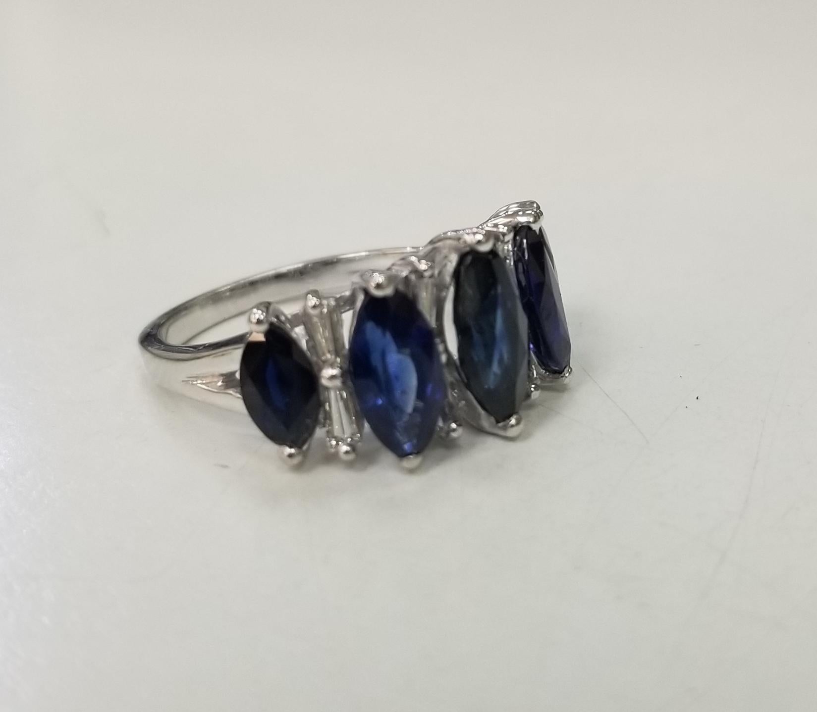 Beautiful platinum sapphire and diamond ring.
Specifications:
    main stone: 5 Marquise Sapphires 3.47 cts. 
    diamond; 8 diamonds weighing approx. .40 cts.
    diamond; clarity: VS
    diamond; color: G
    metal:Platinum
    type:ring 
   