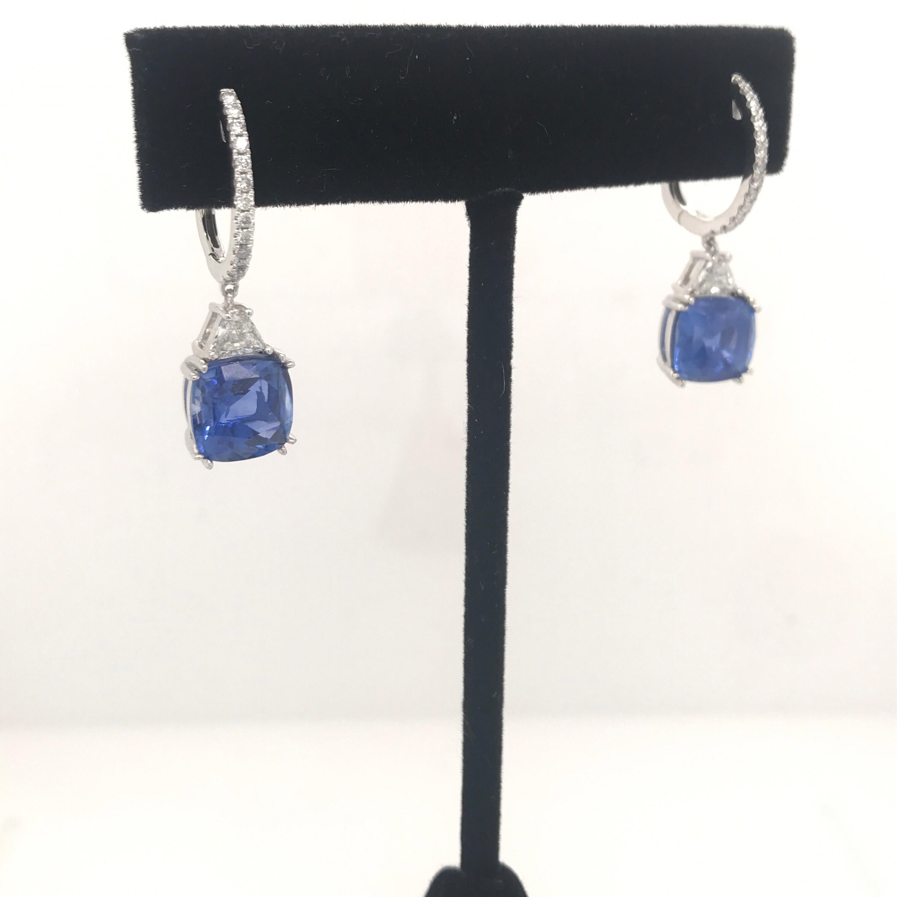 Platinum drop earrings featuring two blue sapphires weighing 8.01 carats, 2 trapezoids weighing 0.45 carats and 26 round brilliants weighing 0.25 carats.