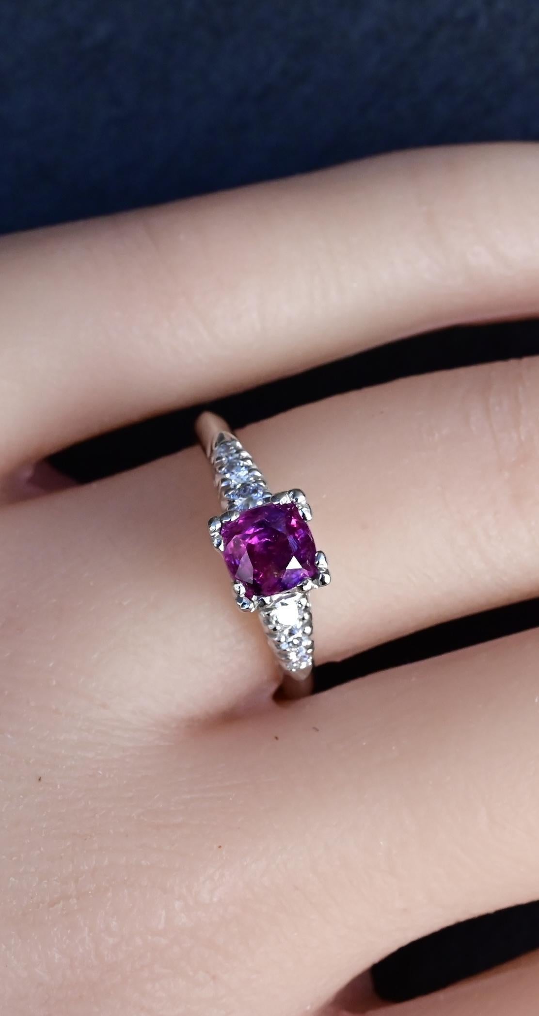 This exquisite platinum ring features a stunning 0.68-carat natural sapphire as its centerpiece, radiating deep red hues that symbolize passion and elegance. Accentuating the sapphire, 0.08 carats of natural diamonds add brilliance and