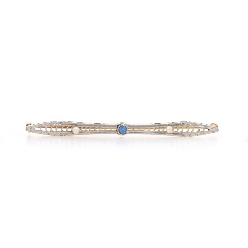 Era: Art Deco
Date: 1920s - 1930s

Metal Content: Platinum (top) & 14k Yellow Gold

Stone Information
Natural Sapphire
Treatment: Heating
Carat(s): .10ct
Cut: Round
Color: Blue

Natural Seed Pearls

Total Carats: .10ct

Style: Bar Brooch
Fastening