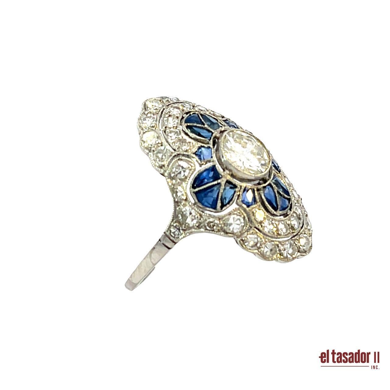 Questo splendido anello smerlato in platino è una creazione unica, realizzata a mano con un'eccezionale attenzione ai dettagli. Al centro, un diamante taglio brillante di 0,70 carati irradia luce, circondato da una delicata disposizione di zaffiri