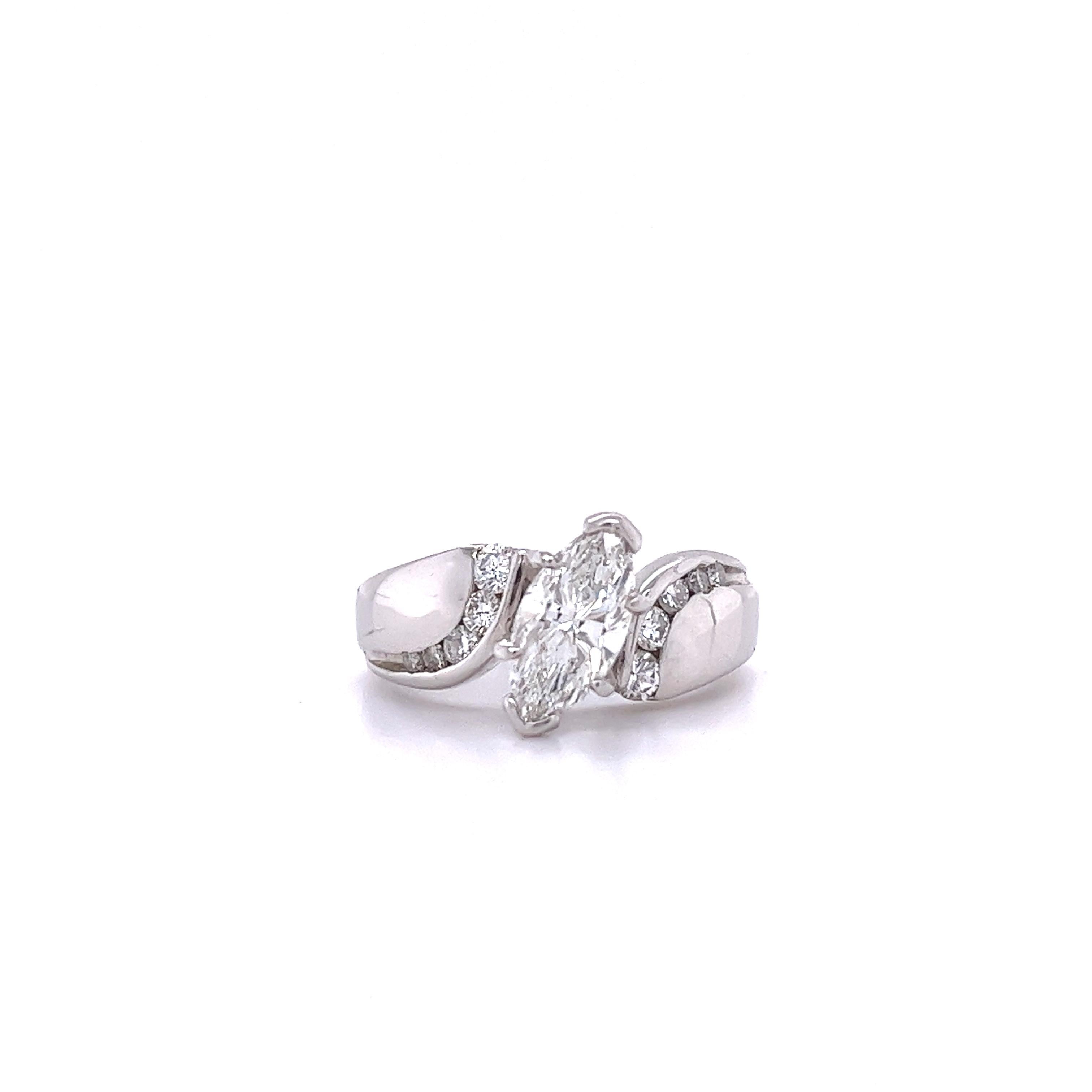 Platinum set natural diamond engagement ring with curvaceous bypass style ring shank. Center stone is 1.20 carats, eye clean, and excellent cut. Set in a secure 4-prong and half bezel setting. The half-bezel protects against the diamond ends from