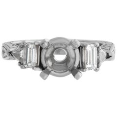 Platinum setting for 1-1.3 carat diamond w/ emerald & triangle cut diamonds