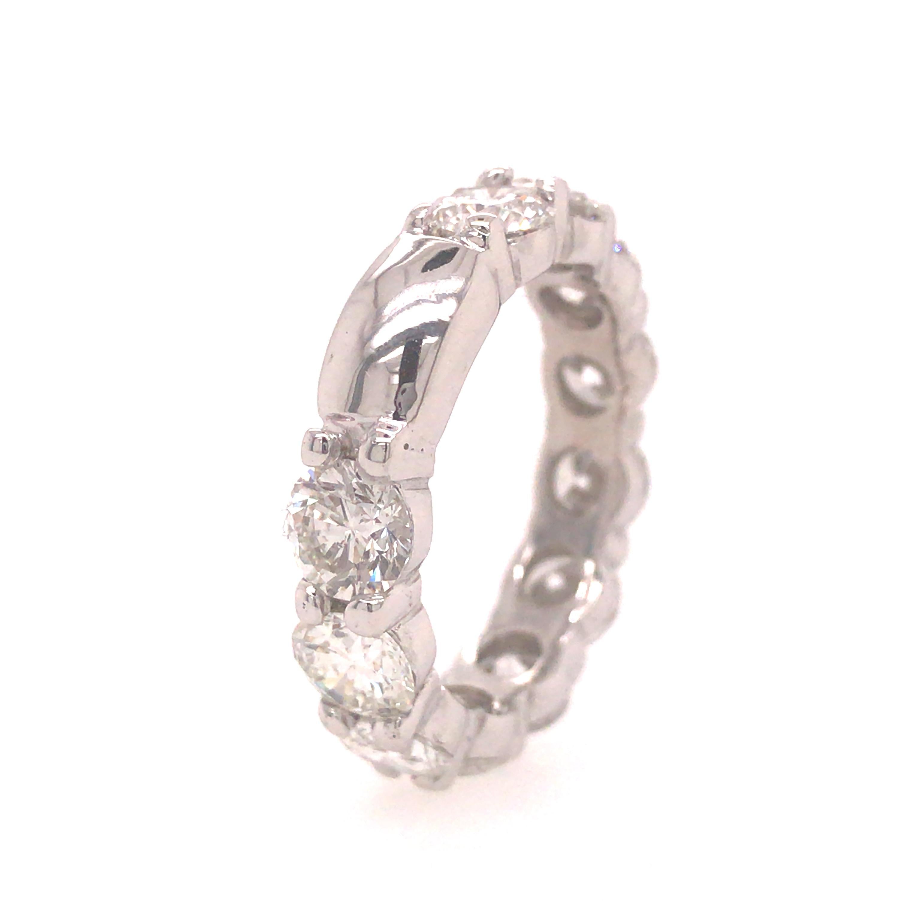 Shared Prong Diamond Eternity Band in Platinum.  (11) Round Brilliant Cut Diamonds weighing approximately 6.05 carat total weight, G-I in color and VS-I1 in clarity are expertly set. 3/16 in width. Ring size 8.  9.17 grams.