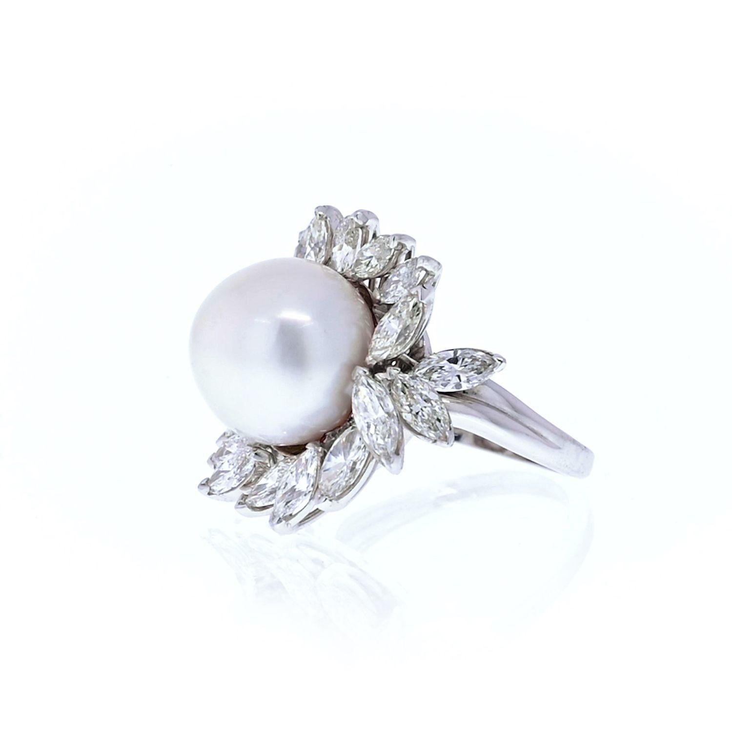 This one of a kind Platinum Pearl & Marquise Diamond Ring weighs approximately 17 grams and showcases a fabulous 13 mm south sea pearl in the center, adorned with 3.95 ctw of dazzling VS clarity marquise cut diamonds, each masterfully prong set in a