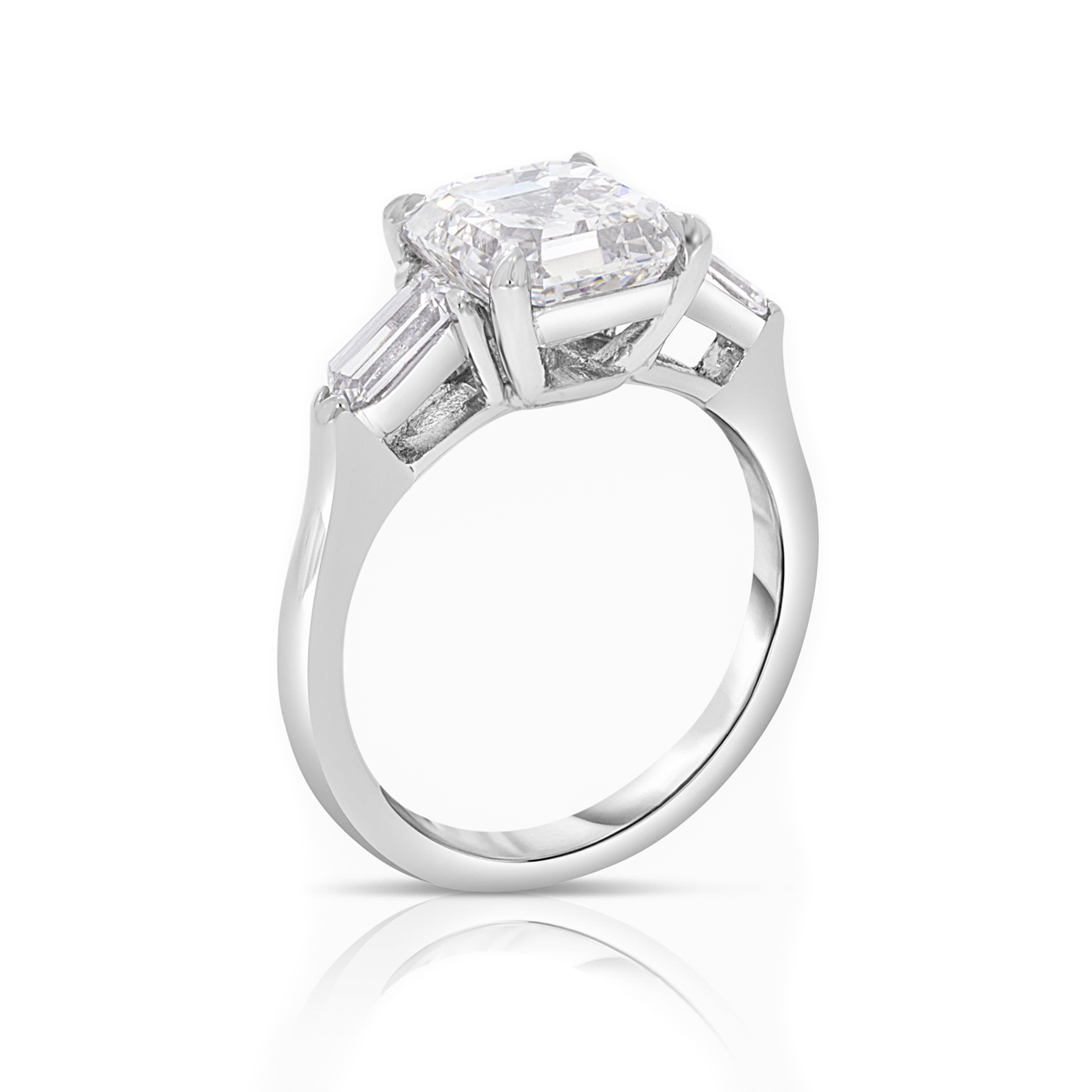 Platinum Engagement Ring with a Square Modified Emerald cut Diamond 3.24 carat w/bullets 0.65 carat total weight. 
1 Square Modified Emerald cut Diamond: 3.24 carat, H color, VVS2 clarity.
2 Bullet cut Diamonds: 0.65 carat, G/H color, VVS2