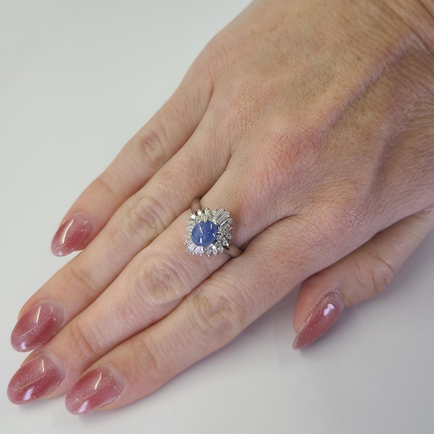 Elegant Platinum Ballerina Ring Featuring A 1.43 Carat Oval Star Sapphire with Crisp Ray Lines. Center Stone is Accented By 0.52 Carat Total Weight Round and Tapered Baguette Cut Diamonds of VS Clarity and G/H Color. Current Finger Size is 6.25;