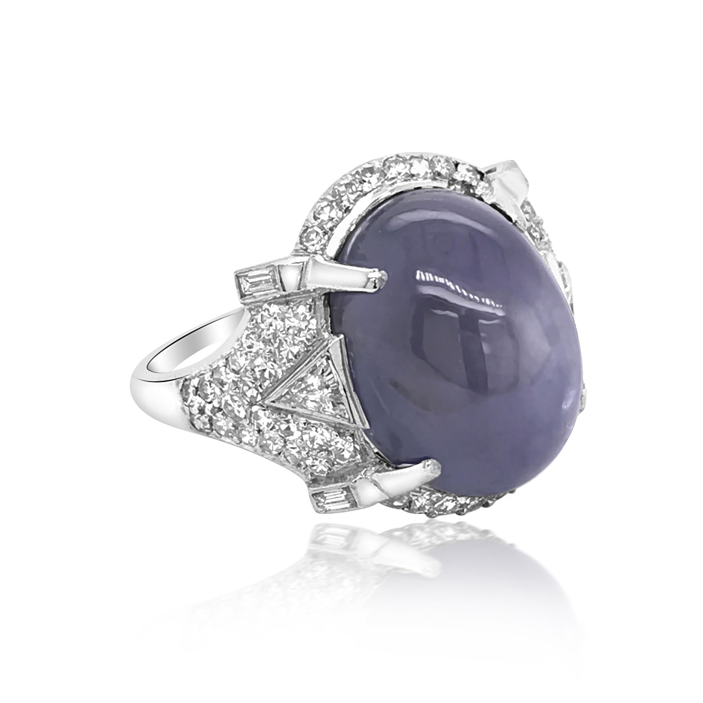 This stunning genuine star sapphire and diamond ring is crafted in solid platinum, weighing 8.48 grams and in size 6.75. Exposing an oval cabochon star sapphire measuring approx. 14.00 x 11.00 x 10.70 mm, weighing approximately, 15ct.Enhanced by