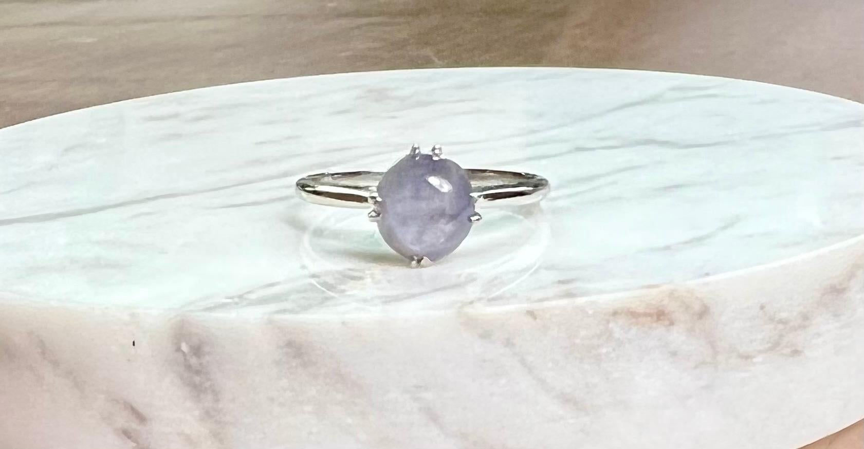 One platinum ring set with one 7mm round cabochon star sapphire.  The ring is a finger size 6.5 and can be resized.  