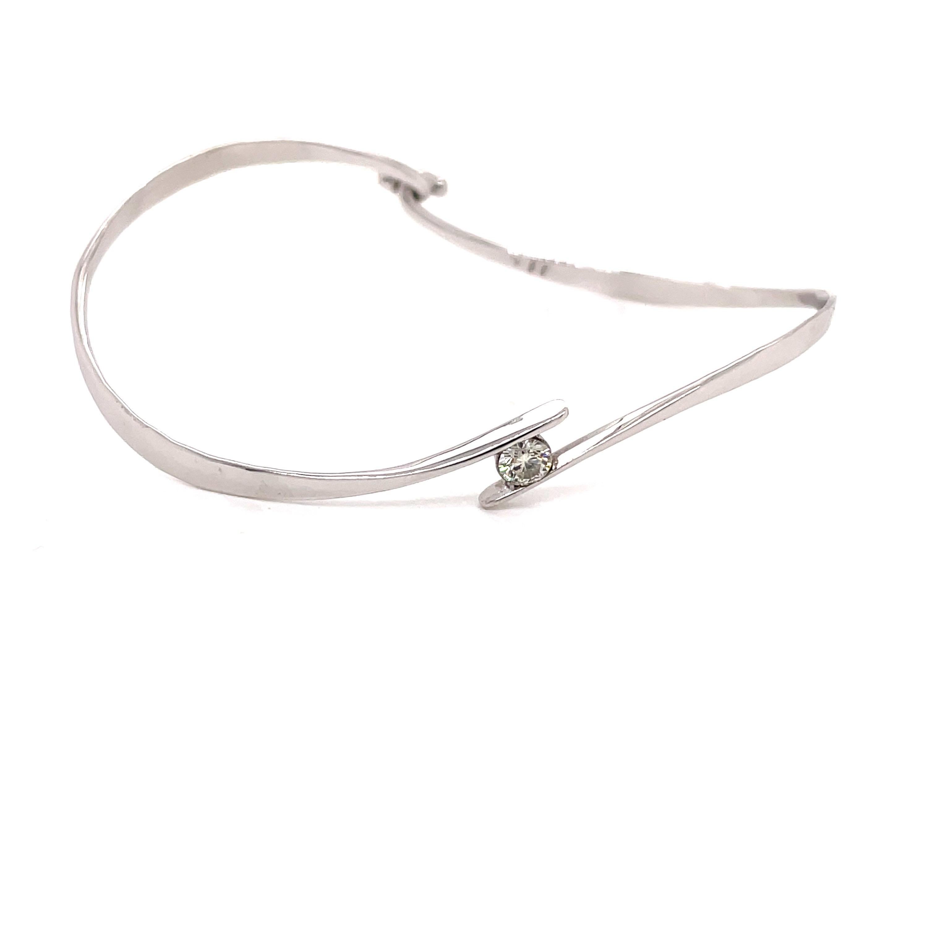 Platinum Swirl Bangle Bracelet with .27ct Diamond - The diamond is H color and VS2 clarity. The clasp is a hook on the bottom and the bangle is stamped PT 950. The inside diameter is 1.75 inches high and 2.5 inches wide. The bangle weighs 8.34 grams.