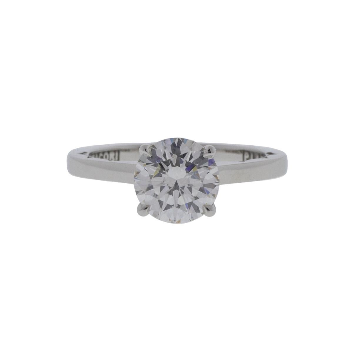 This platinum Tacori round brilliant diamond ring is a timeless symbol of love and commitment. Its 1.13ct F color VS1 clarity diamond gives a brilliant sparkle within an elegant 4-prong setting. The band has lovely embellishments to add to the