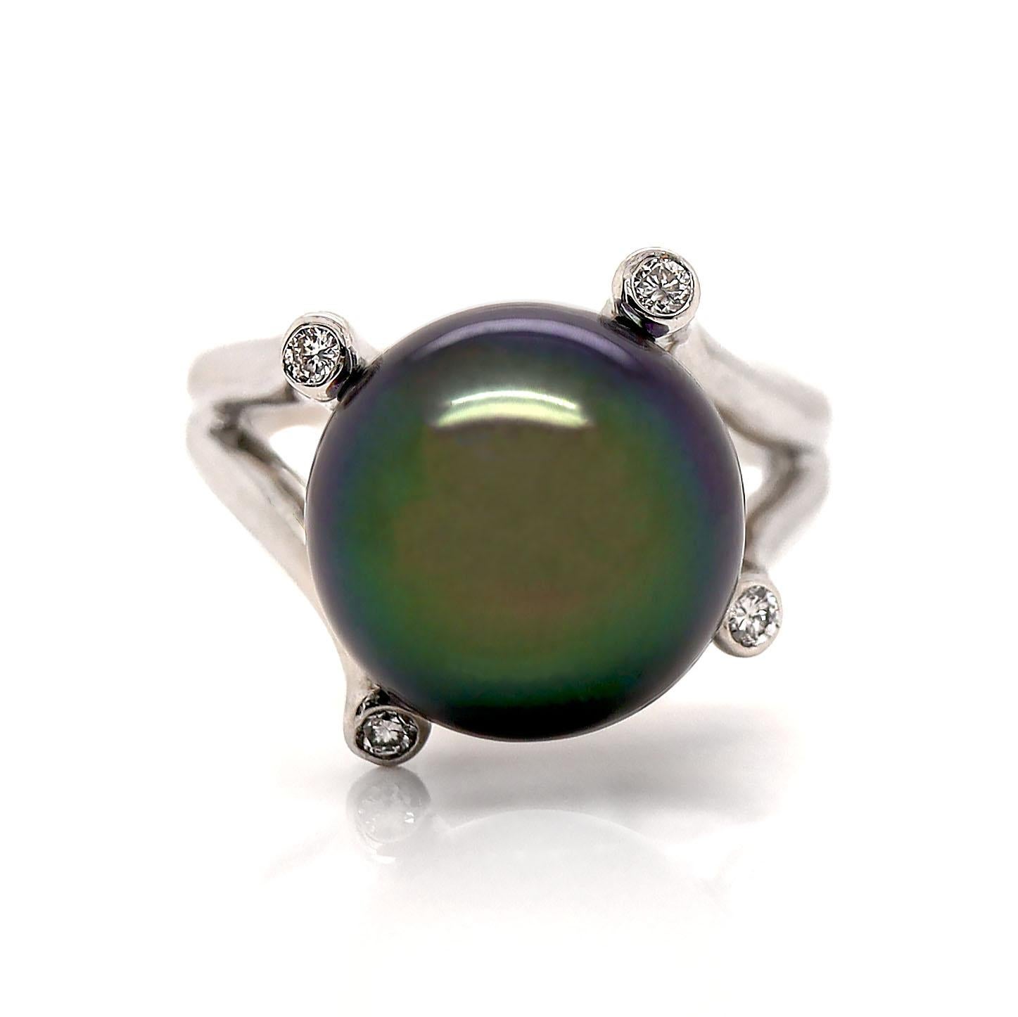 Platinum Tahitian Pearl And Diamond Cocktail Ring

This exquisite cocktail ring features a striking 12.70mm near-round Tahitian pearl, black color enhanced by shimmering purple, green, and gold overtones, flanked by four round brilliant cut