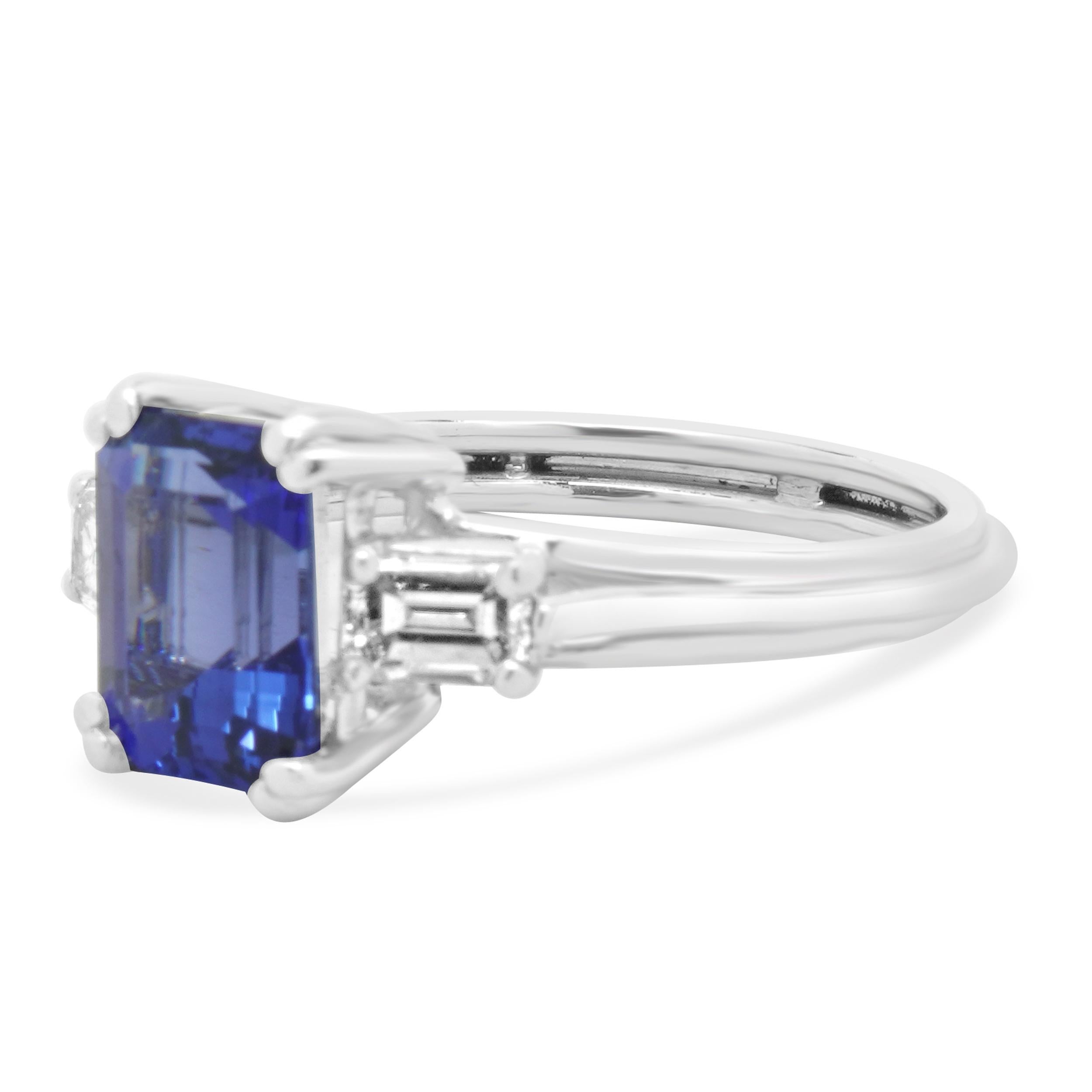 Designer: custom
Material: platinum
Diamond: 2 emerald cut = 0.50cttw
Color: H
Clarity: VS1-2
Tanzanite: 1 emerald cut = 2.74ct
Dimensions: ring top measures 9mm wide
Size: 7.5
Weight: 6.62 grams