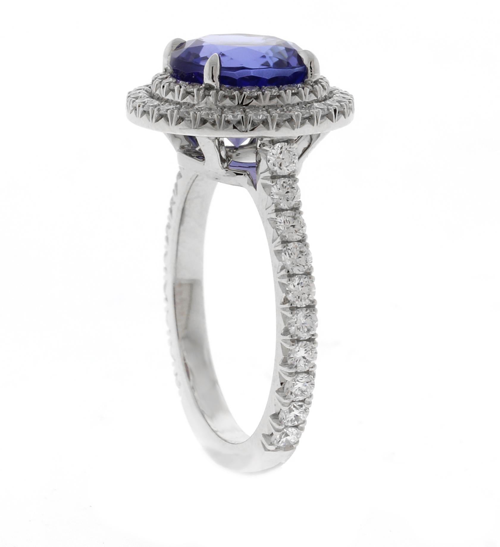 This custom-designed platinum ring by master craftsmen of Pampillonia Jewelers features a stunning 3.02-carat round tanzanite as the center gem. Surrounding and accenting the tanzanite are 72 brilliant-cut diamonds totaling 0.72 carats, set in a