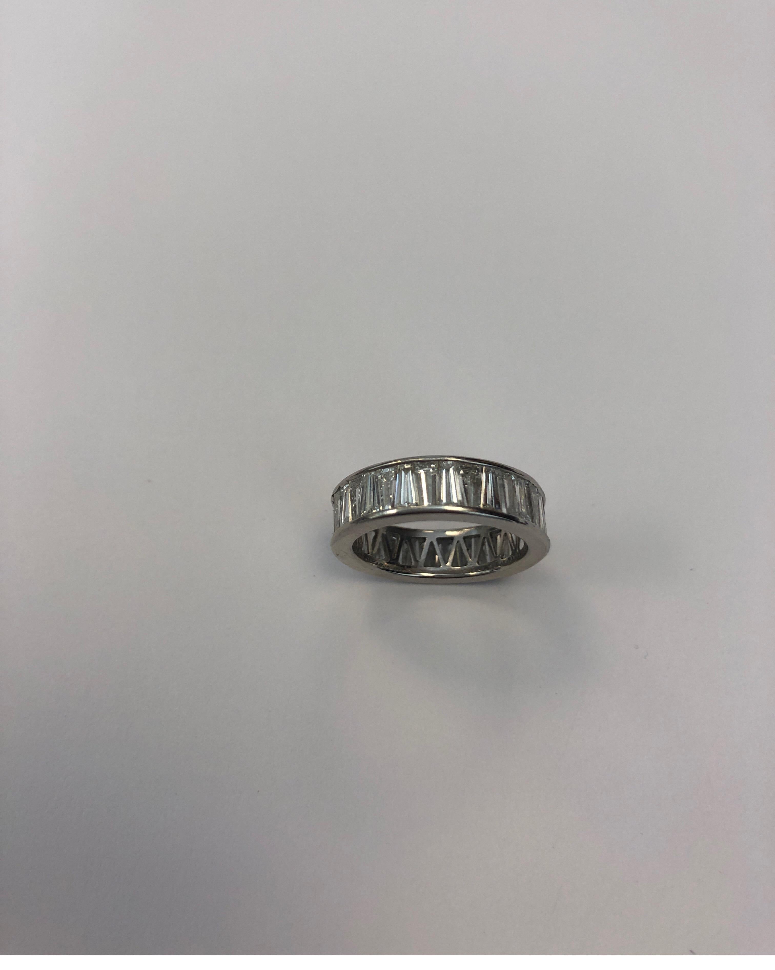 Platinum wedding/eternity band, channel set with 34 tapered baguette diamonds, FG color, VS clarity. 5.4mm width
Finger size 4.75
Retail $11,500