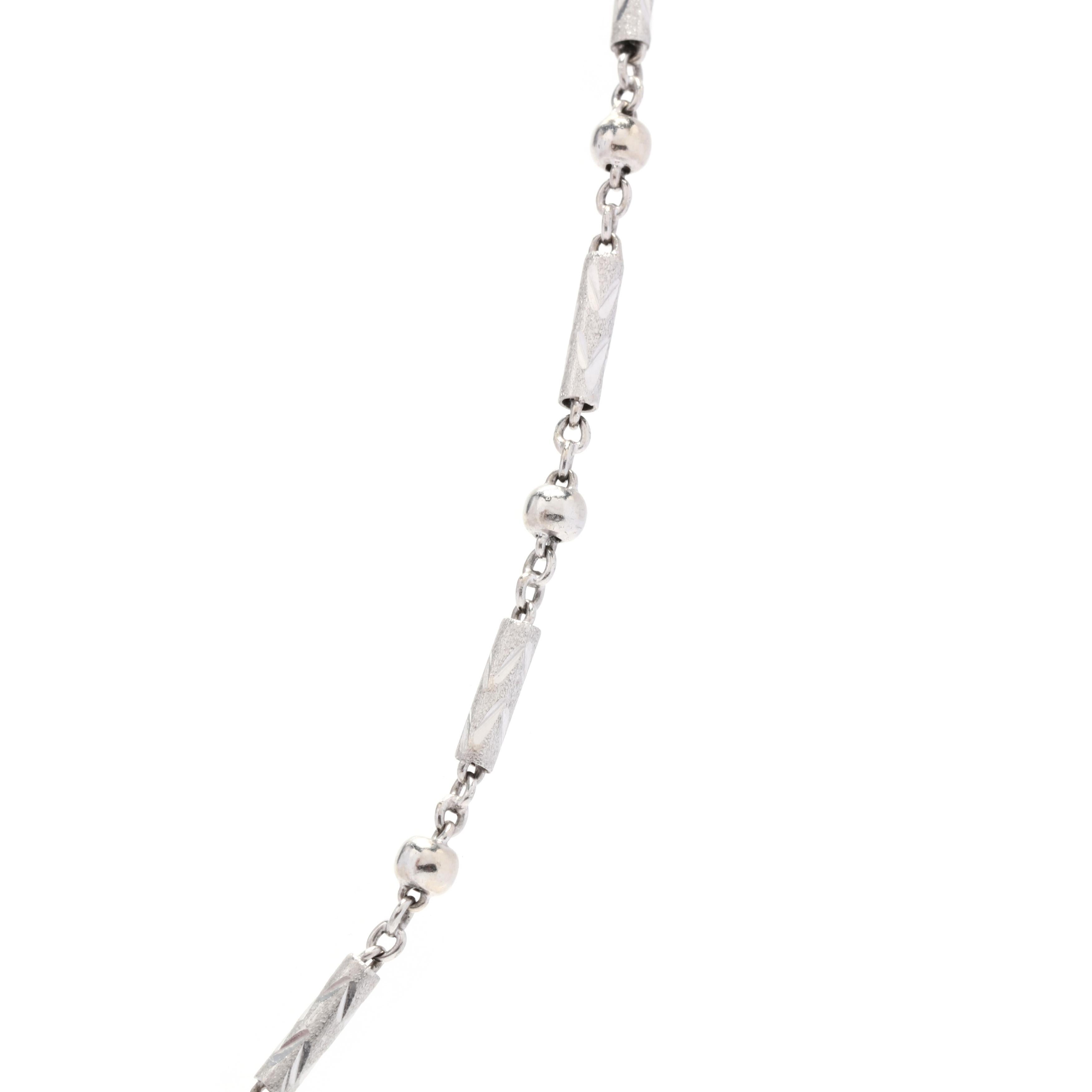 A vintage platinum bar and bead chain. This chain features alternating engraved textured bar links with polished round bead links and an S link clasp.



Length: 16.5 in.



Width: 3 mm



Weight: 5.8 dwts.