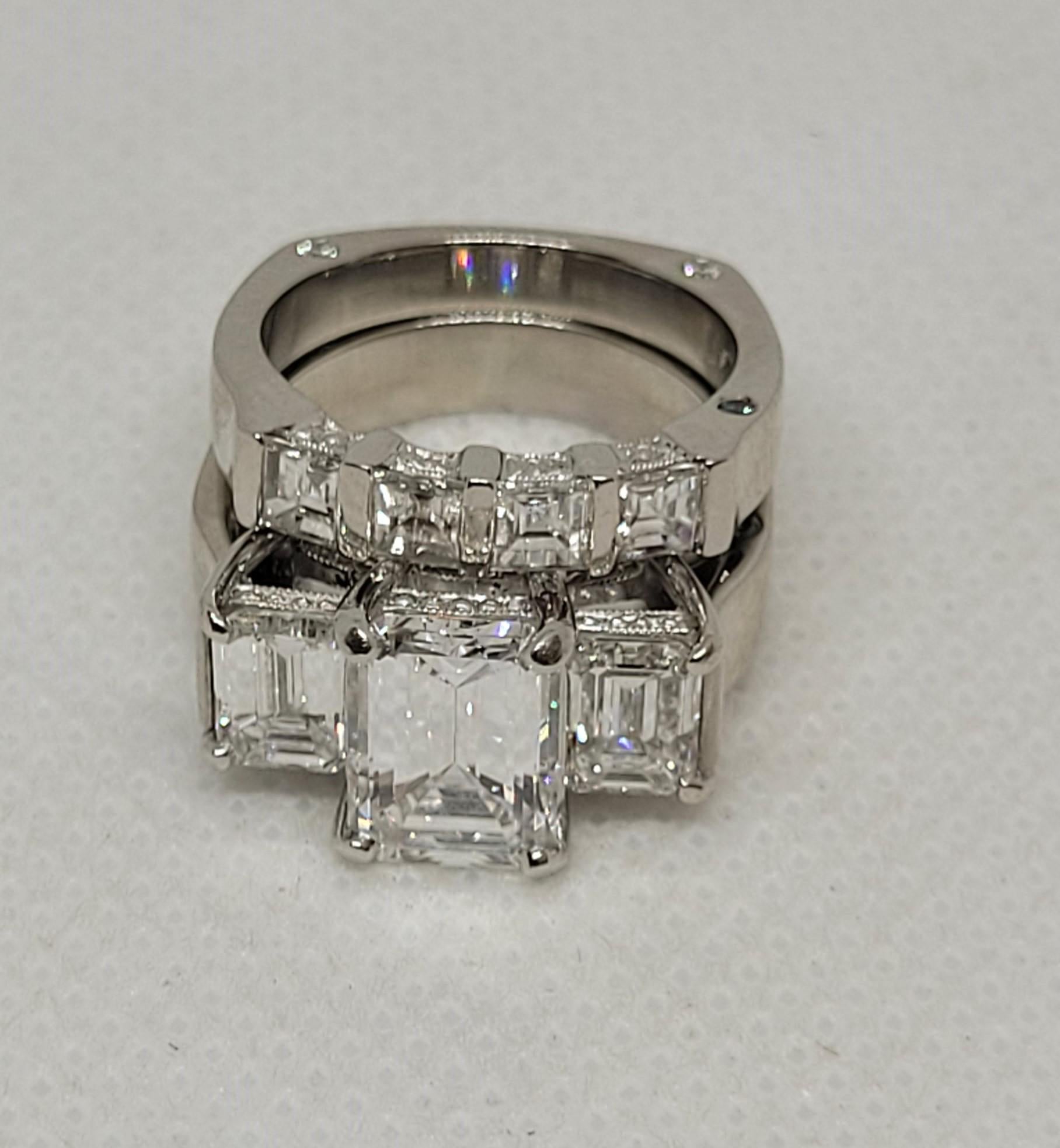 Gorgeous platinum wedding set designed by Rock N Gold Creations. The 3-stone engagement ring has a GIA-certified centerstone 2.01ct  D/VS2 accented with 2 - emerald cut diamonds 1.36cttw, G/VS1. The collection quality diamonds are set in a