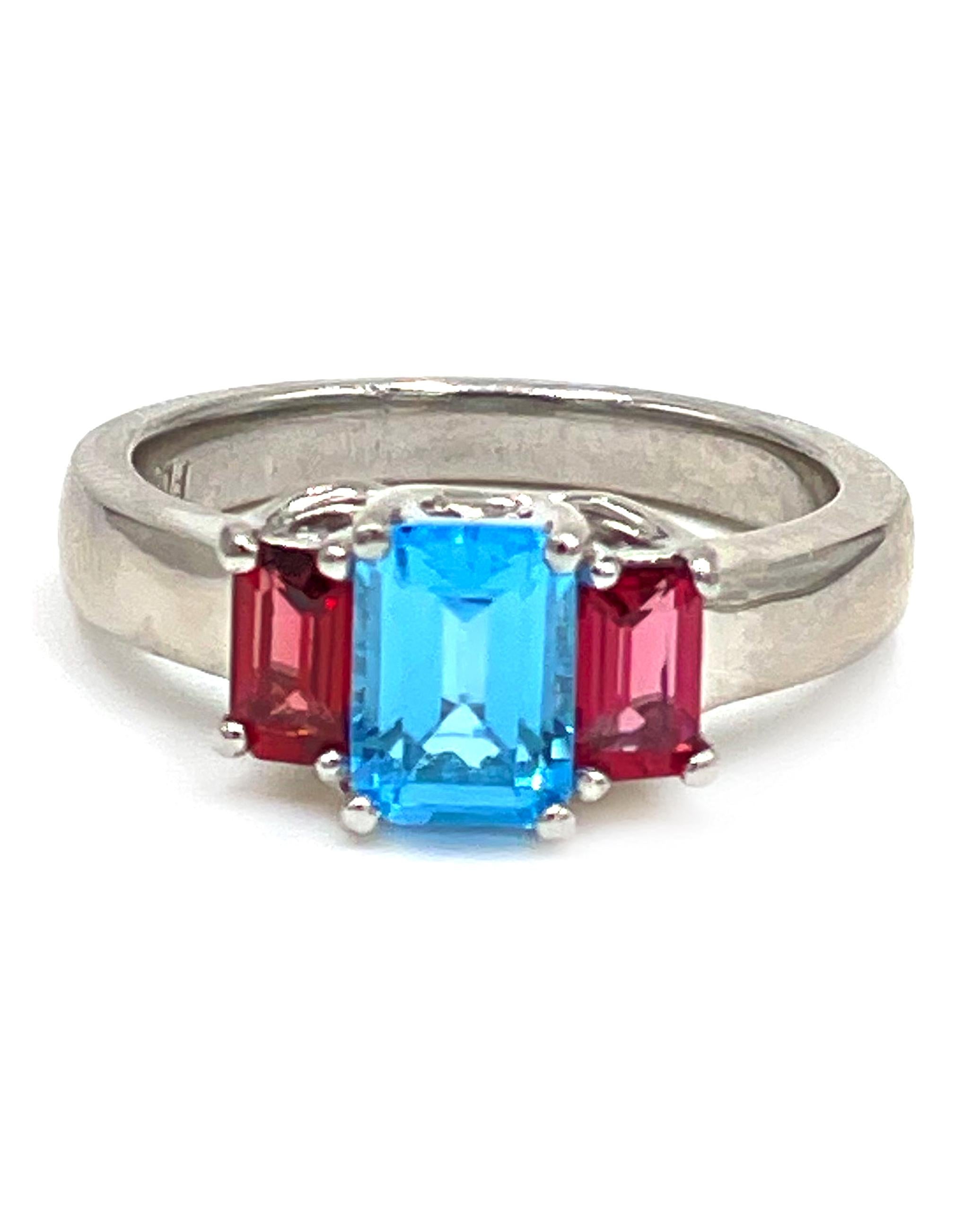 Platinum three stone Lucida set ring with two step cut pink tourmaline 0.75 carats and one center step cut sky blue topaz 1.35 carats.

- Finger size 6