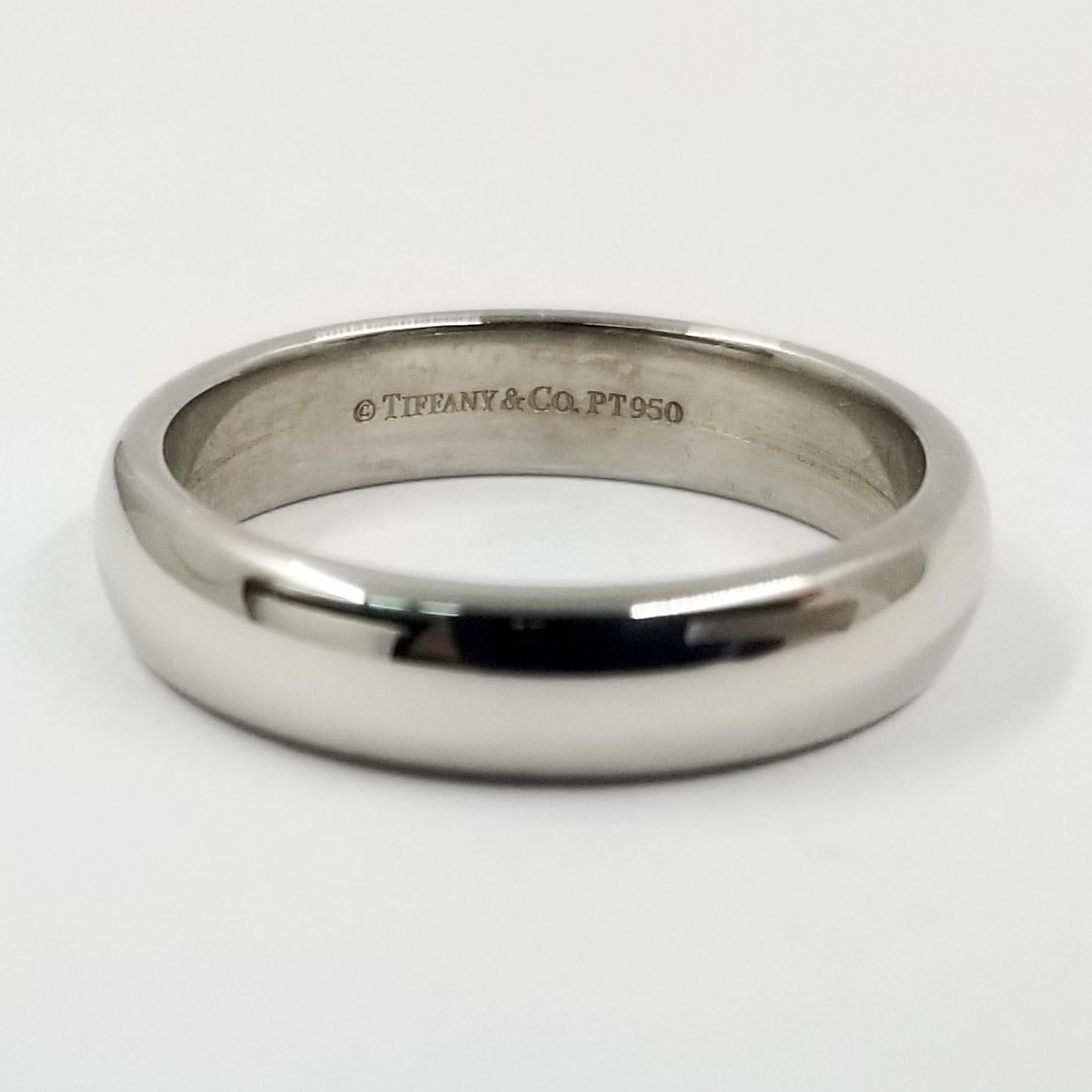 This simple half round wedding band from Tiffany & Co is crafted in platinum with a high polish shine. The interior is stamped PT950. Width is approximately 4.5 millimeters. Current finger size is 7.75; purchase includes free sizing (up or down 1