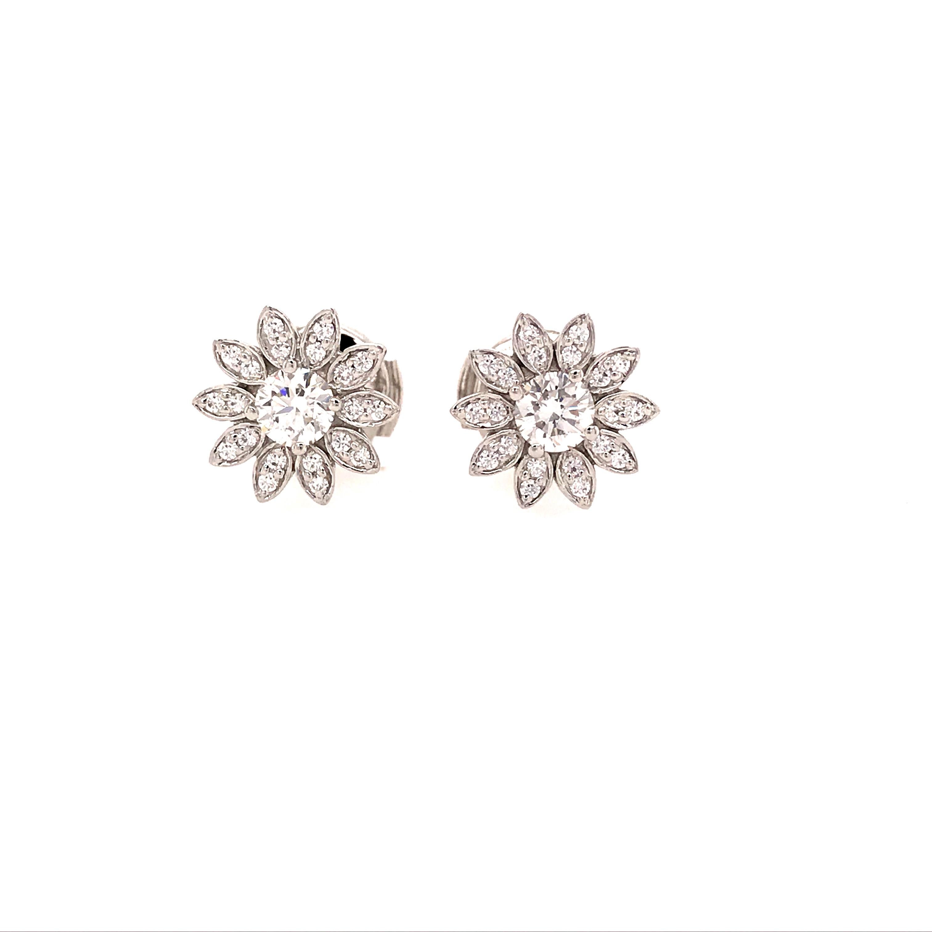 Tiffany & Co. Enchant Diamond flower earrings in Platinum. Expertly set with (42) Round Brilliant Cut Diamonds weighing .50 carat total weight, G-H in color and VS in clarity.  The earrings measure 3/8 inch in diameter and weigh 3.75 grams.  Stamped