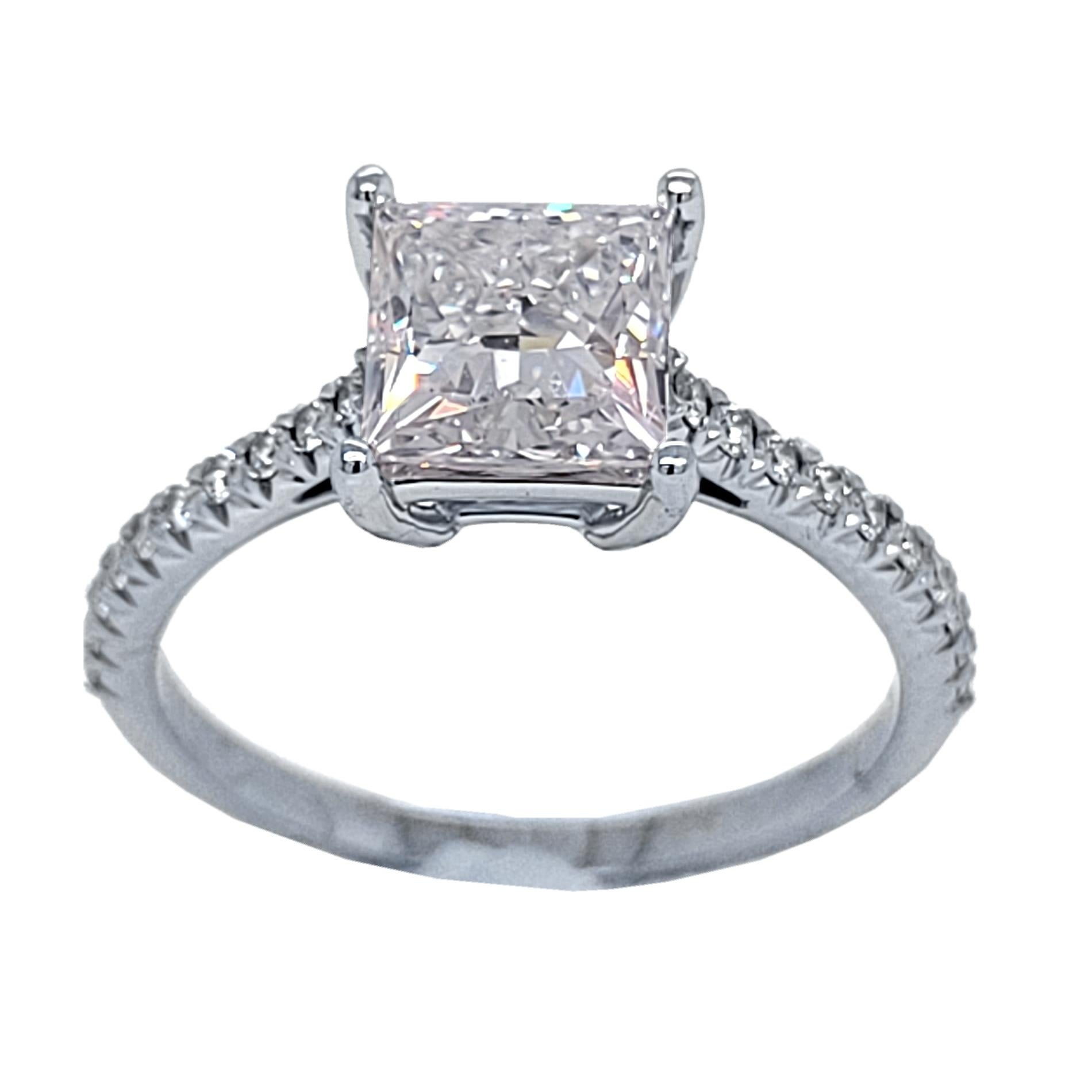 Tiffany & Co., platinum Novo® diamond Engagement ring and wedding band set. Emgagement Ring's center stone is one GIA certified princess cut diamond weighing 1.51 ct. The stone is lifted above the scintillating diamond band to create an