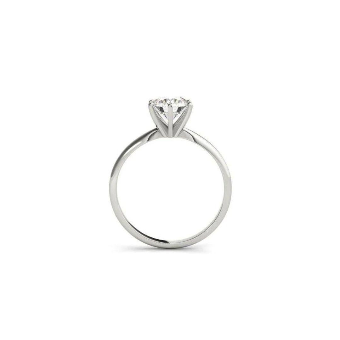 Classic Platinum Tiffany Style Solitaire Diamond Engagement Mounting﻿. 0.25 ctw, H color, SI clarity. Six prong platinum head holds a certified round brilliant cut natural white diamond, 0.71 ct weight, E color, VS2 clarity