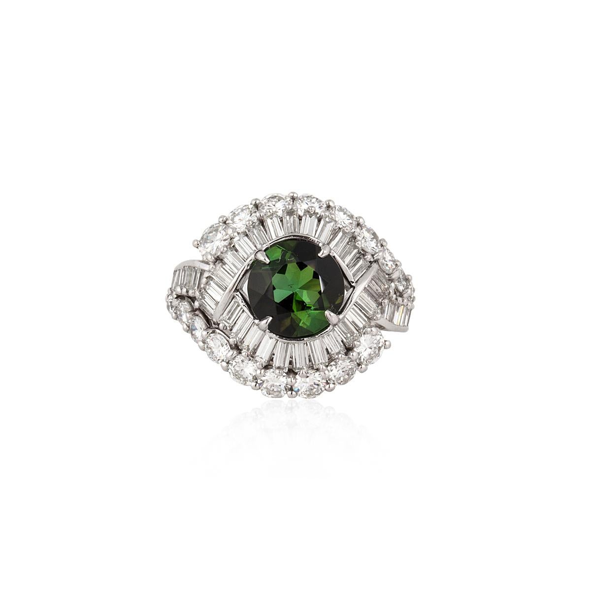 Platinum ring featuring a round green tourmaline weighing 1.80 carats, accented by round and baguette diamonds.  There are 18 round diamonds totaling 1.60 carats; G-H color and VVS2-VS2 clarity and 38 baguette diamonds totaling 1.40 carats; G-H