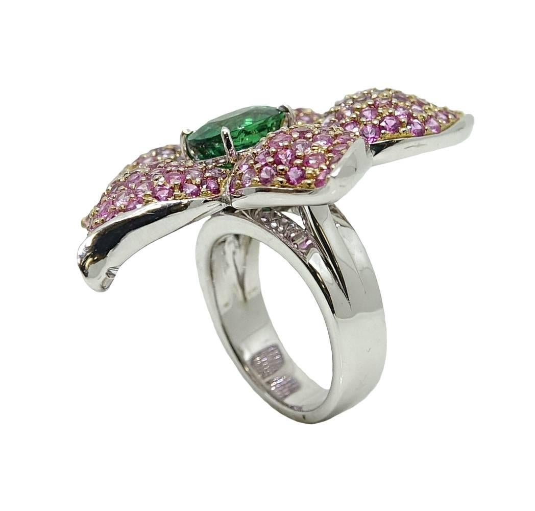 This Blooming Platinum Floral Ring Has An Eye Catching Oval Tsavorite Garnet Weighs A Total Carat Weight Of 3.17 Carats, And Is Set In The Center Of This Ring. The Petals On This Flower Ring Have An Ombre Tone With Purple Toned Sapphires Fading Into
