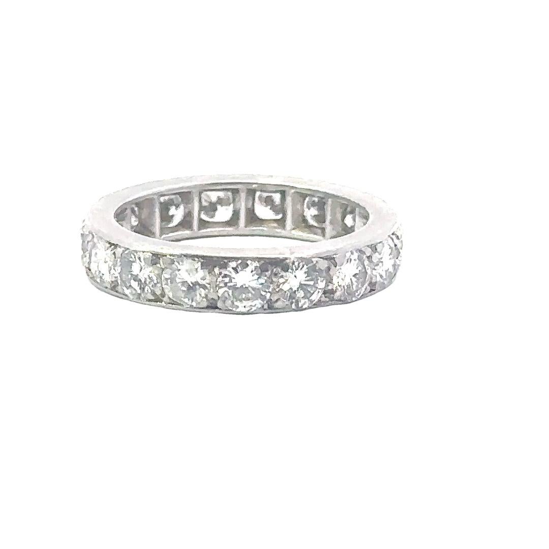 Immerse yourself in the allure of timeless glamour with this Platinum Van Cleef & Arpels 1960s Diamond Eternity Ring. Crafted to perfection, this exquisite piece is a testament to the unparalleled artistry and sophistication that defines the iconic