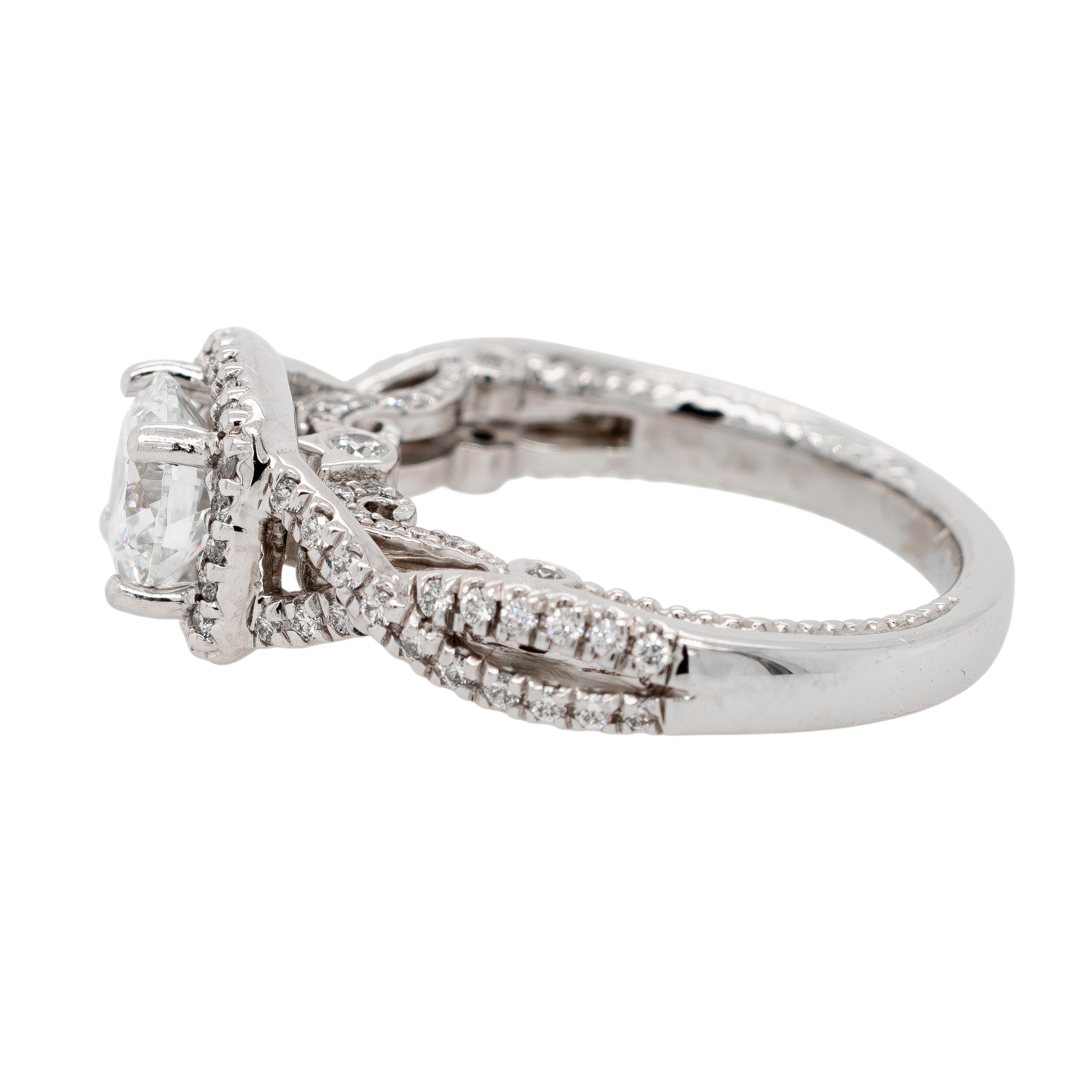 This Verragio Platinum engagement ring epitomizes luxury and timeless beauty. The ring showcases a dazzling 1.01-carat natural round brilliant diamond, graded H color and VS1 clarity by IGI (report #2658014). This exquisite center stone is set in a