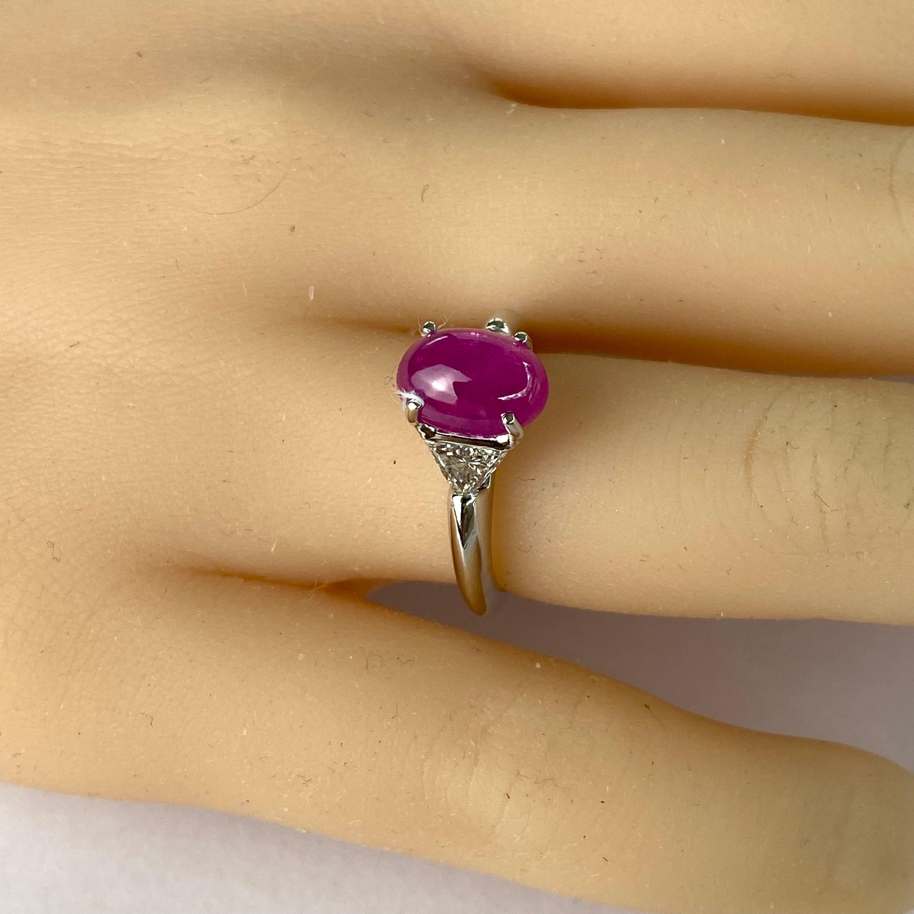 Elevate your engagement with this exquisite vintage-inspired ring, crafted to captivate hearts and ignite everlasting love. This platinum masterpiece features a mesmerizing Cabochon Burma Red Ruby as its center stone, weighing a magnificent 3.70