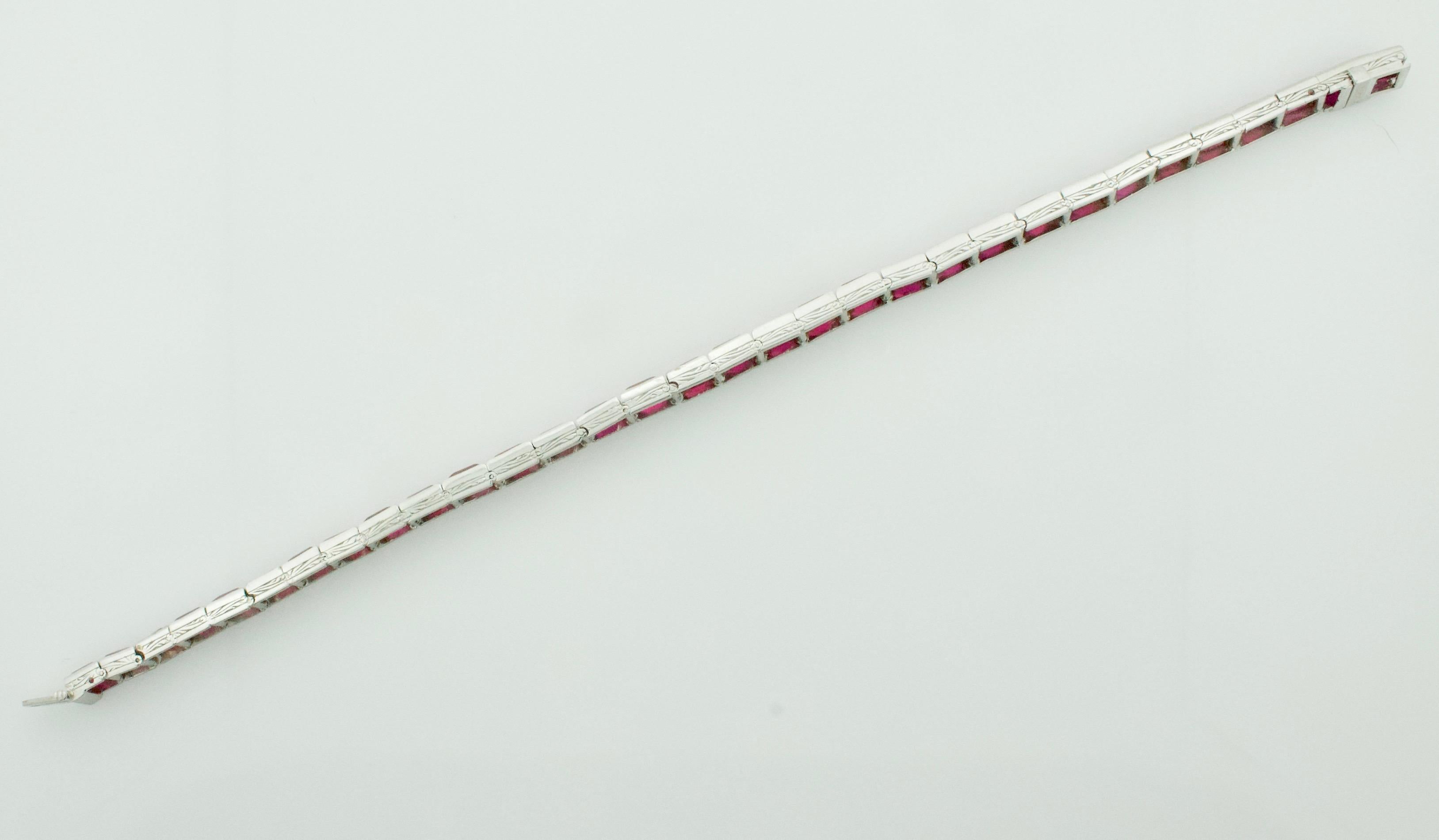 Vintage Synthetic Ruby Straight Line Bracelet Circa 1930's 
Thirty Two Baguette Cut Synthetic (man made) Rubies weighing 12.00 carats approximately   
7 1/8 inches in length


