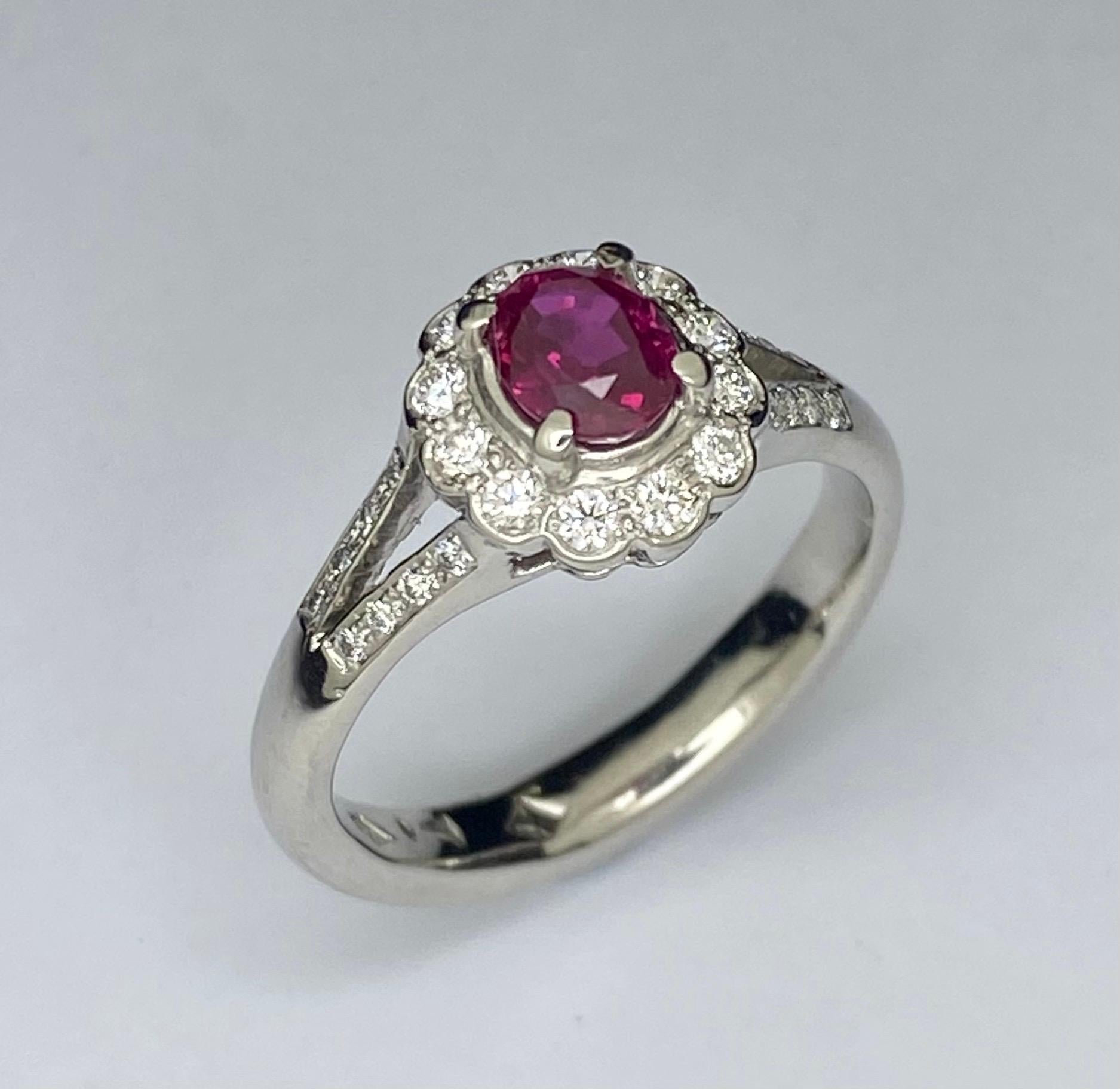 Platinum Vivid Ruby Diamond Cluster Ring

Elegant vintage style contains an oval vivid red ruby secured in a four claw setting. Surrounding the ruby is 12 round brilliant cut diamonds in bezel setting forming a scallop cluster head. Split band to