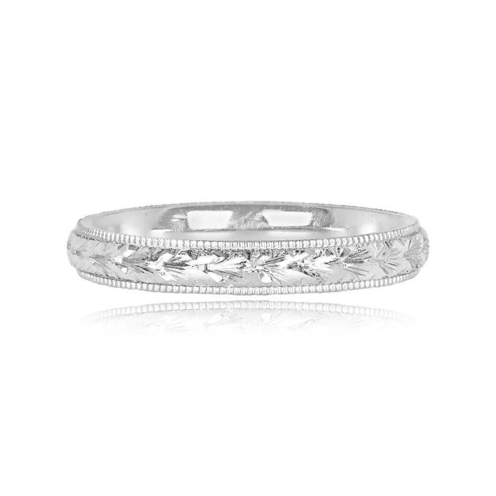 An elegant platinum wedding band with a 3mm width, showcasing a meticulous hand-engraved design inspired by the Art Deco era. The intricate pattern extends around the entire circumference of the band, and delicate milgrain detailing enhances its