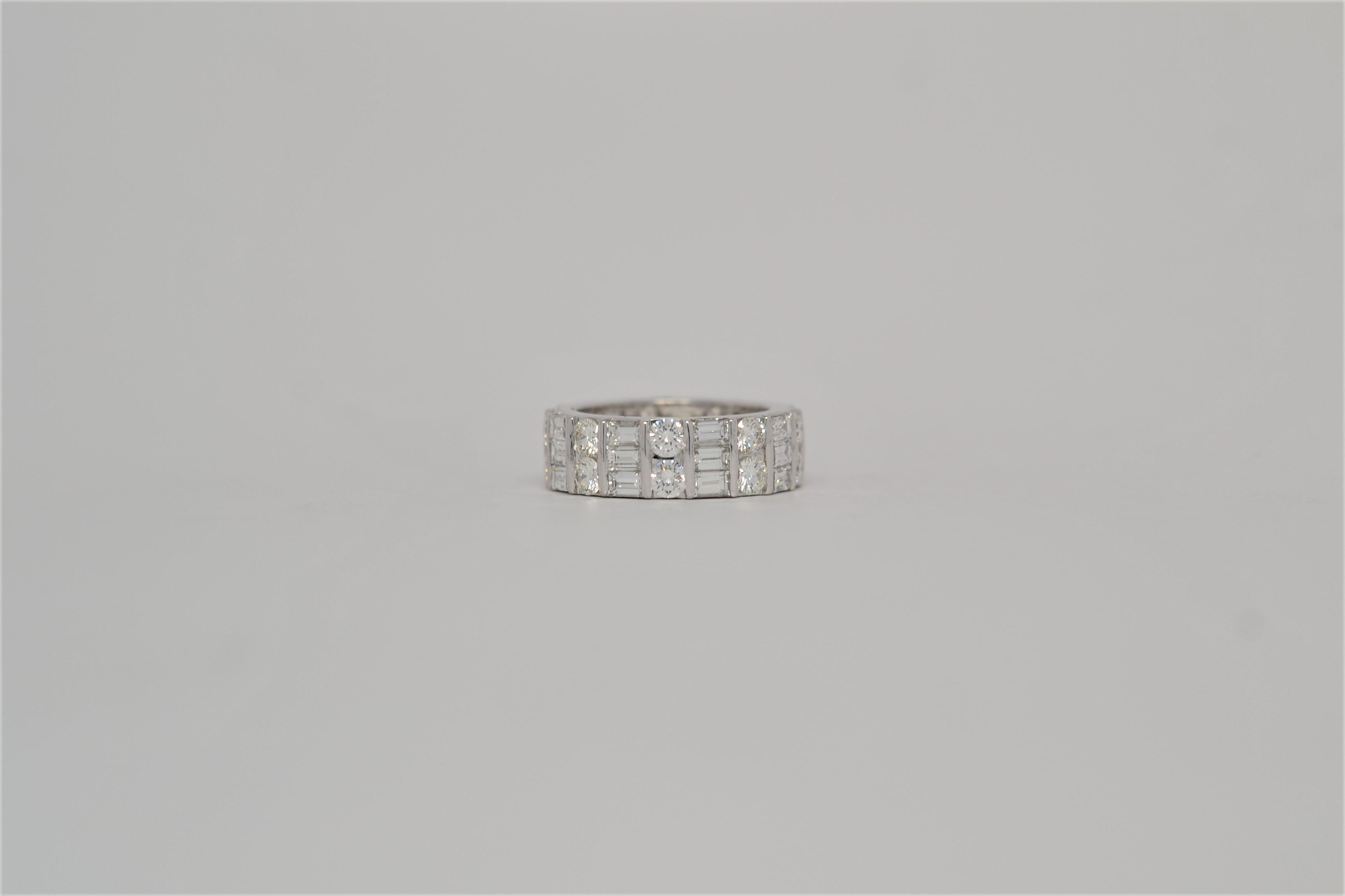 An elegant and finely made Platinum wedding band set all the way around with diamonds in an eternity style layout. Baguette and Round Brilliant Cut Diamonds are channel set in alternating rows. Twenty seven Baguette Shaped Diamonds weigh 2.92ct,