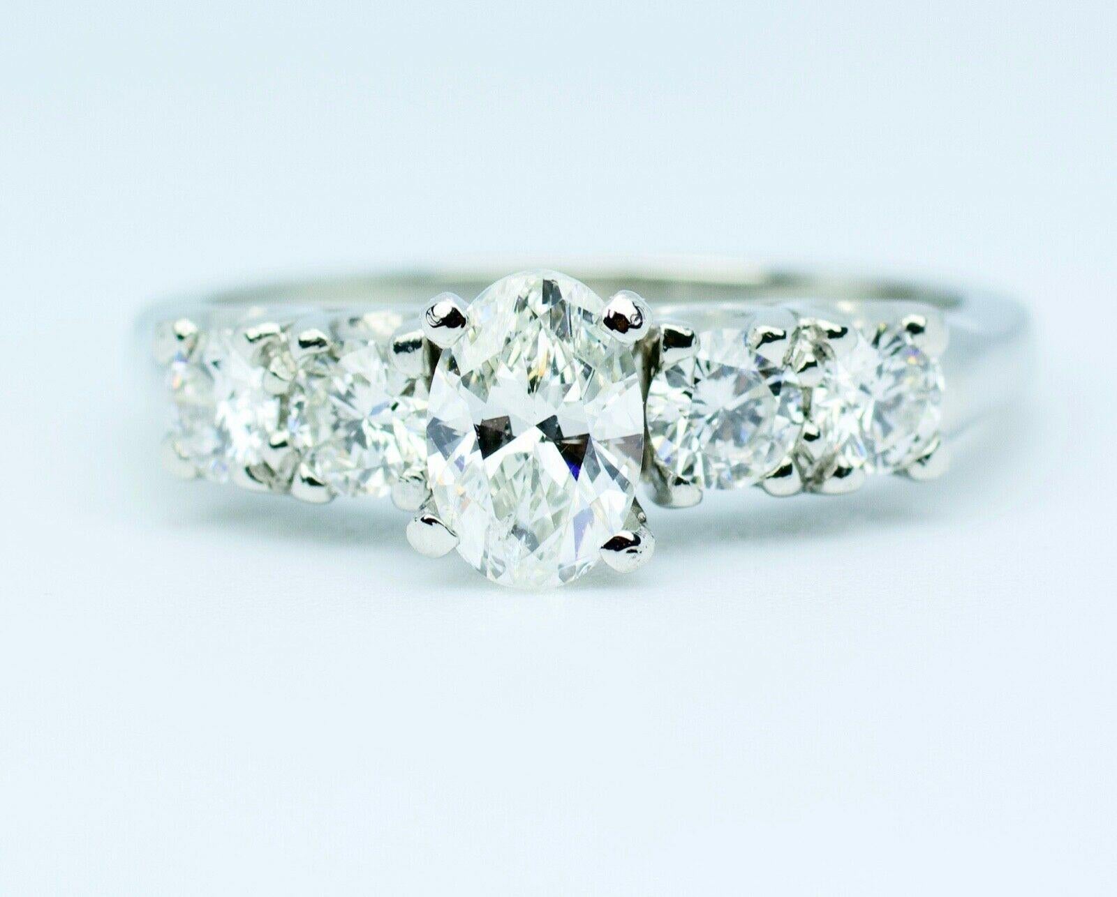 Modern Platinum White Oval Diamond Center with Round White Diamond Ring