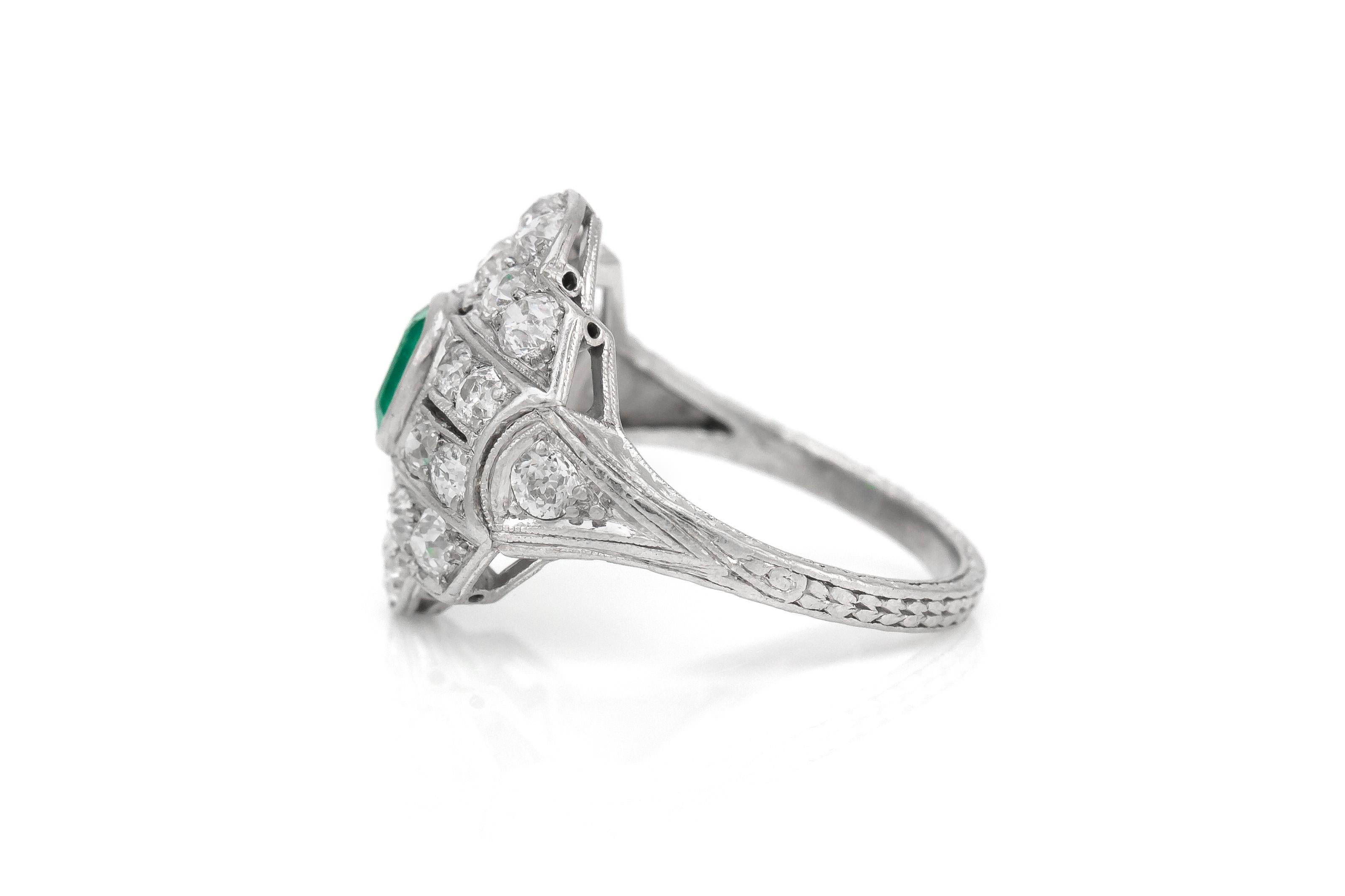 The ring is finely crafted in platinum with center stone emerald weighing approximately total of 0.50 and diamonds weighing approximately total of 1.60 carat.