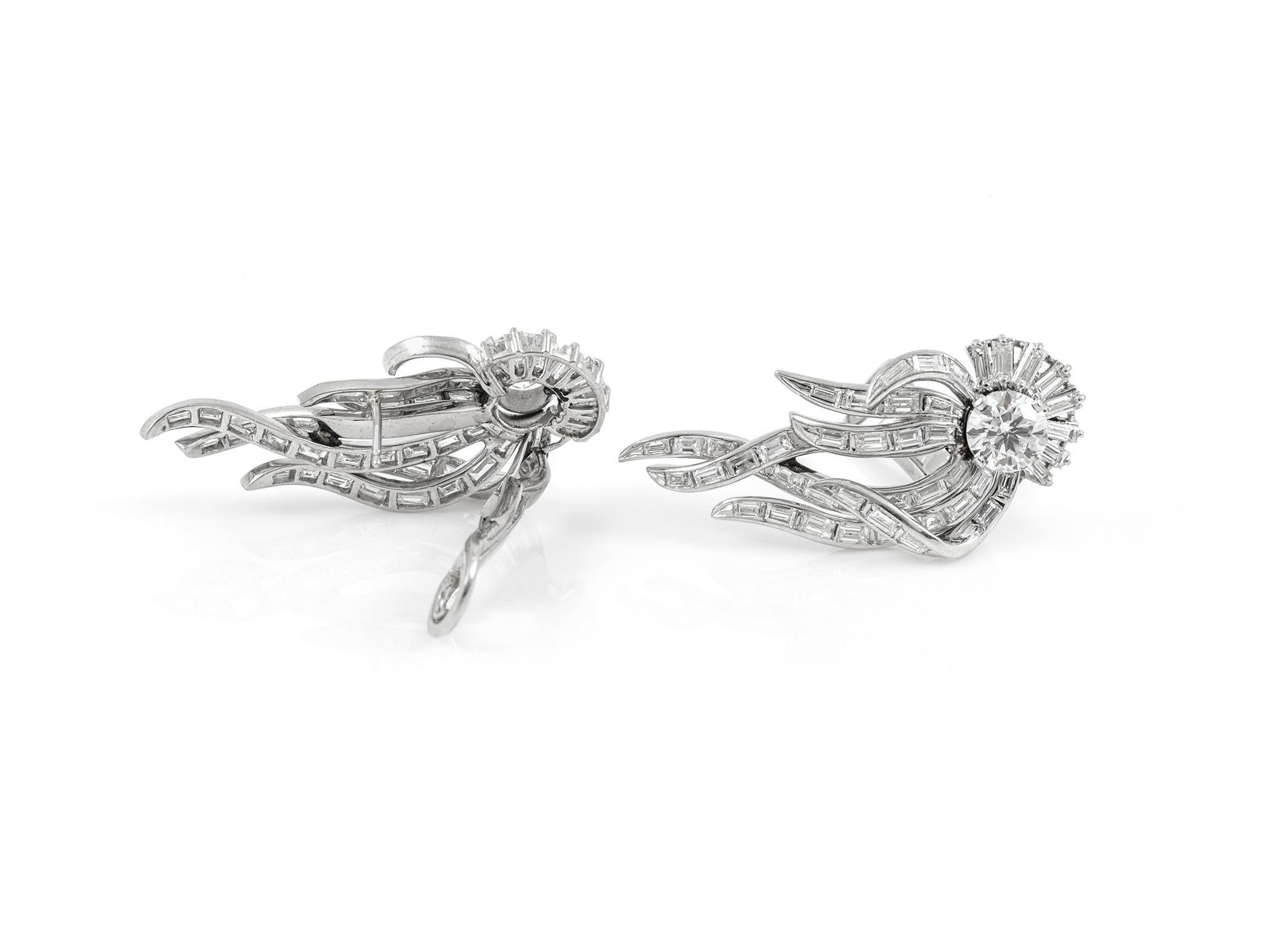 The earrings are finrly crafted in platinum with two center round diamnds weighing approximately total of 2.60 carat and all around diamonds weighing approximately total of 5.00 carat.