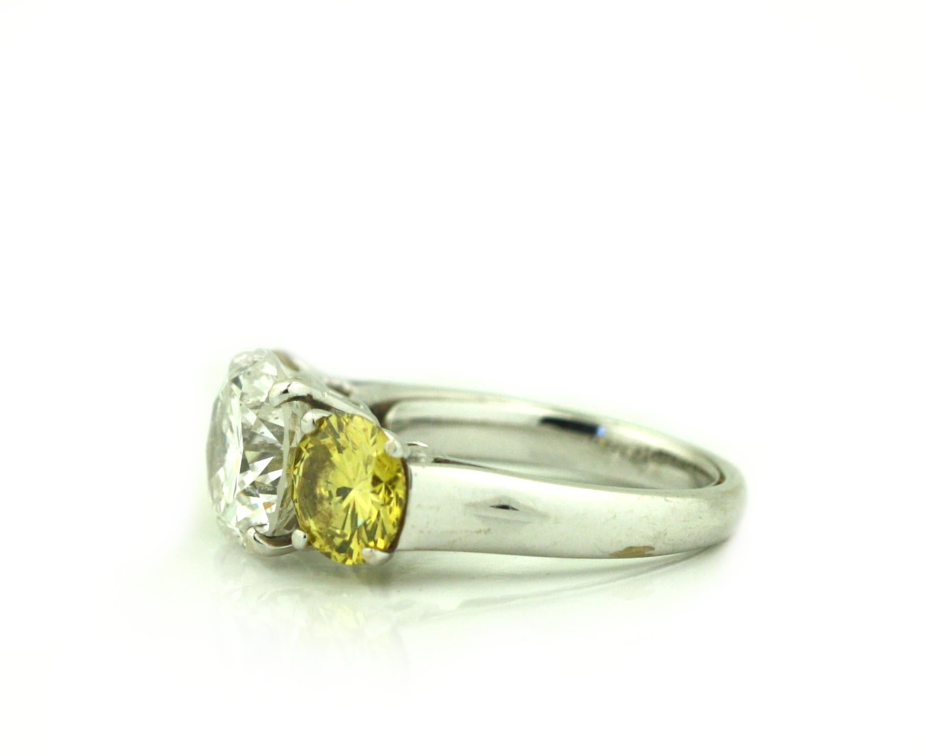 Platinum, Yellow Diamond and Diamond Three Stone Engagement Ring In Good Condition For Sale In Palm Beach, FL