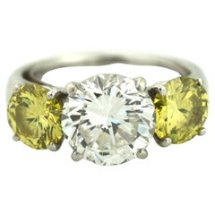 Platinum, Yellow Diamond and Diamond Three Stone Engagement Ring