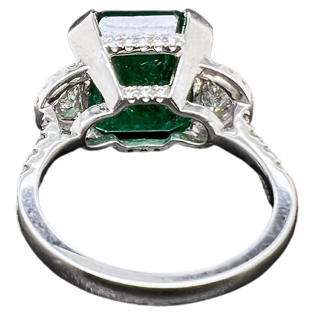 Contemporary Platinum Zambian Emerald Ring with Half Moon Diamonds For Sale