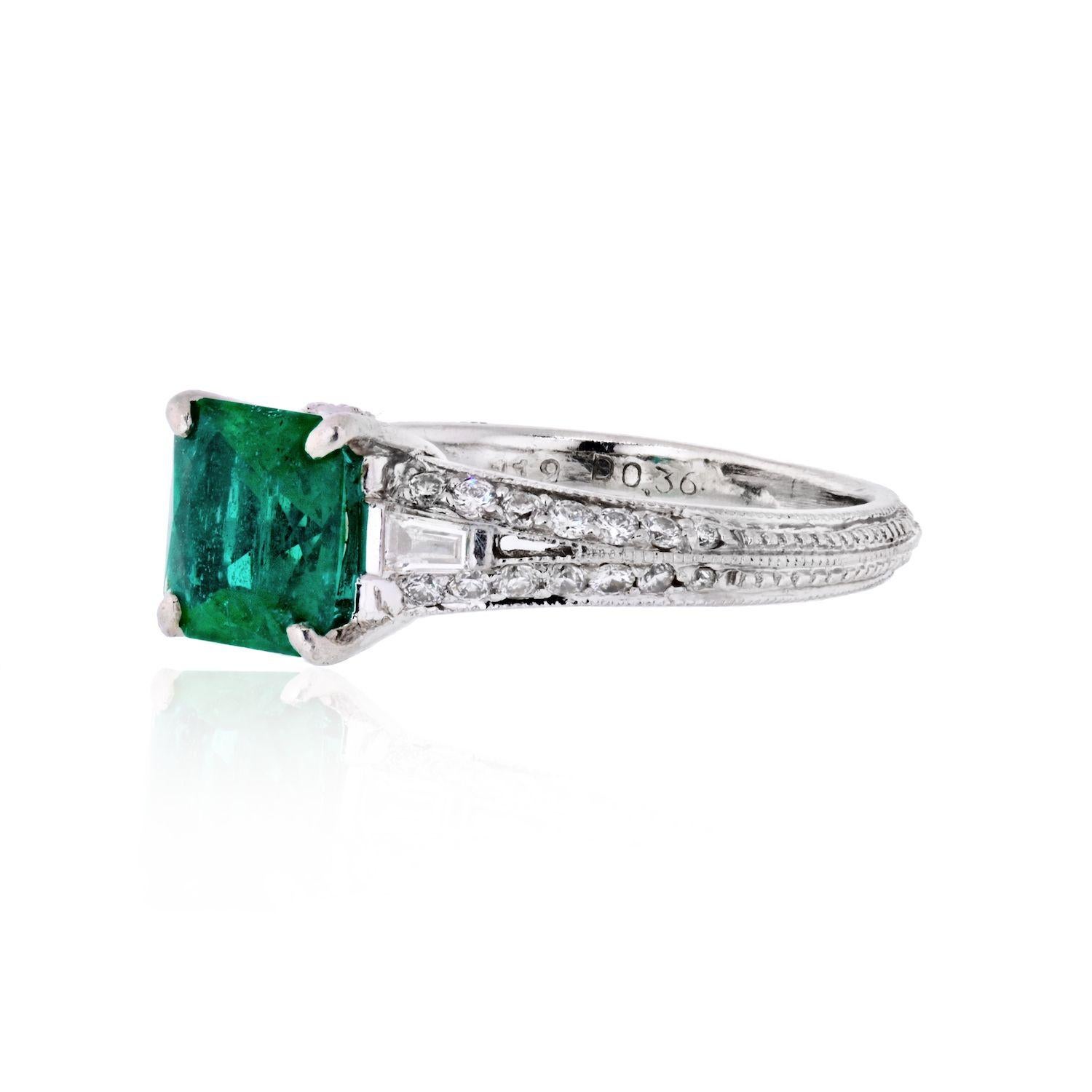 Three carat emerald ring in an antqiue mounting. Platinum setting accented by pave diamonds and hand engraving. 
Size: 6 
Center stone: 7mm 