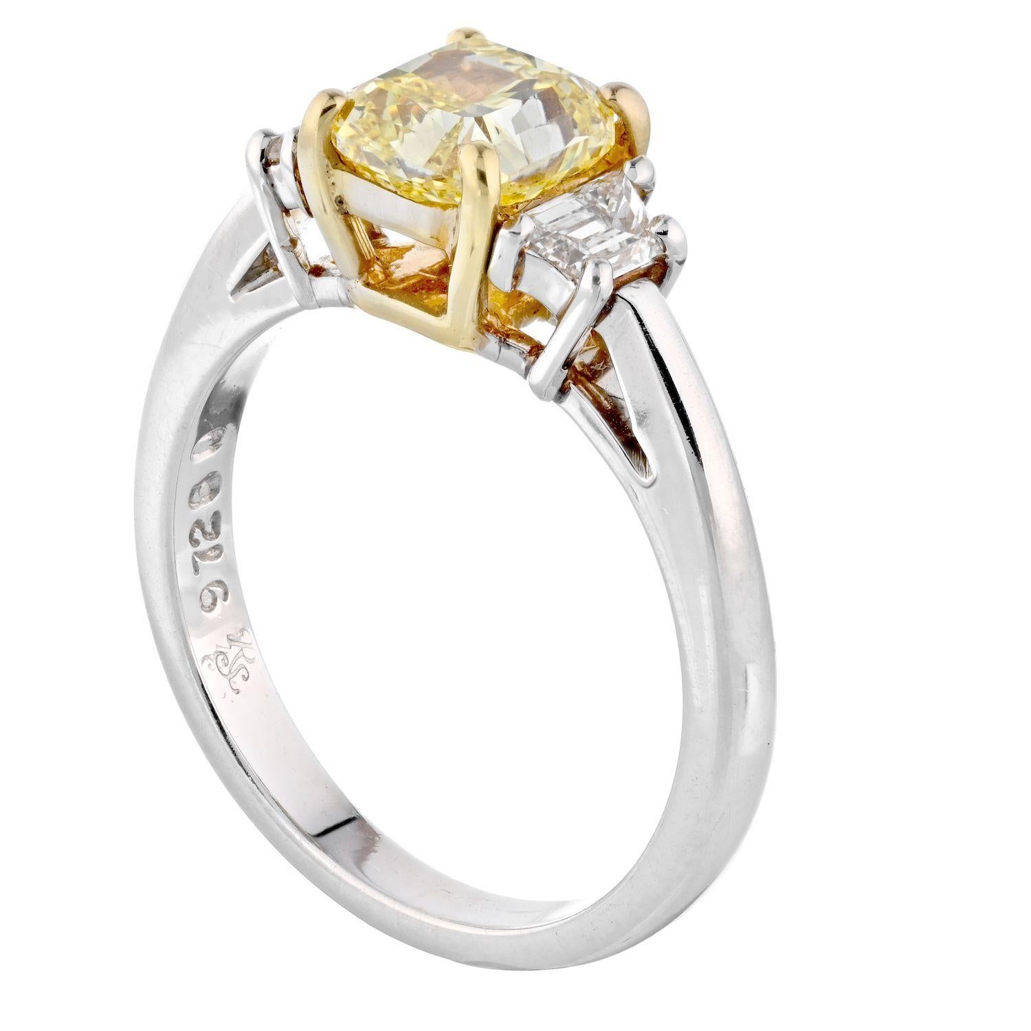 Very elegant and stylish this is a radiant cut fancy yellow diamond engagement ring. Structured as a three stone diamond ring this beautiful engagement ring features a center diamond of 1.51 carats that is a natural fancy yellow diamond. Best of all